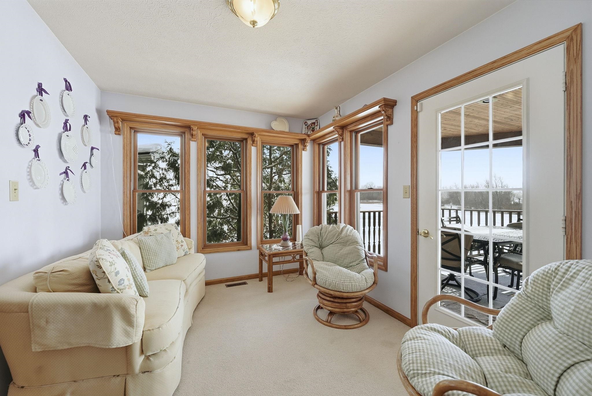 Carpeted living area featuring baseboards