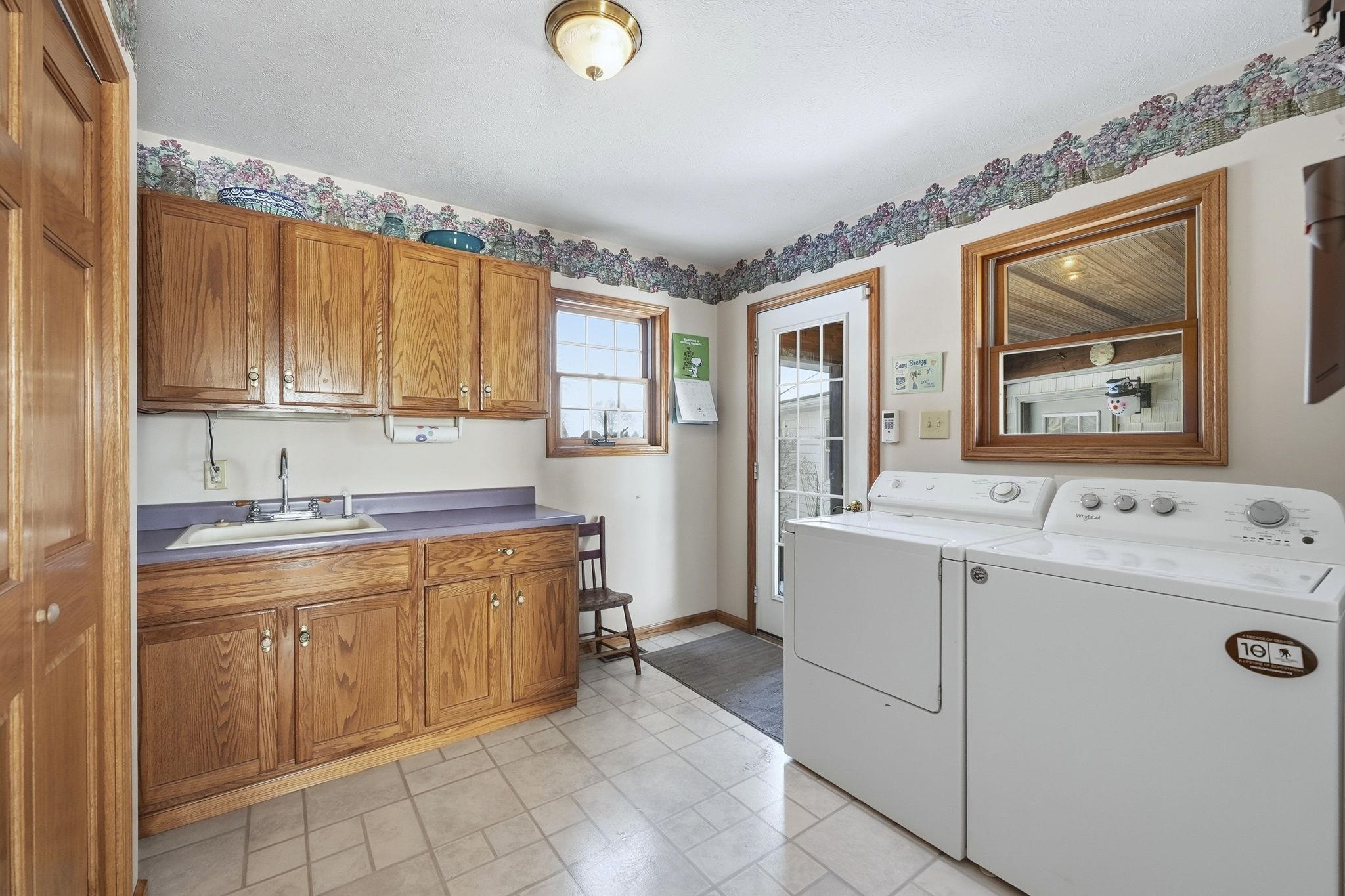 Laundry area featuring independent washer and dryer and cabinet space