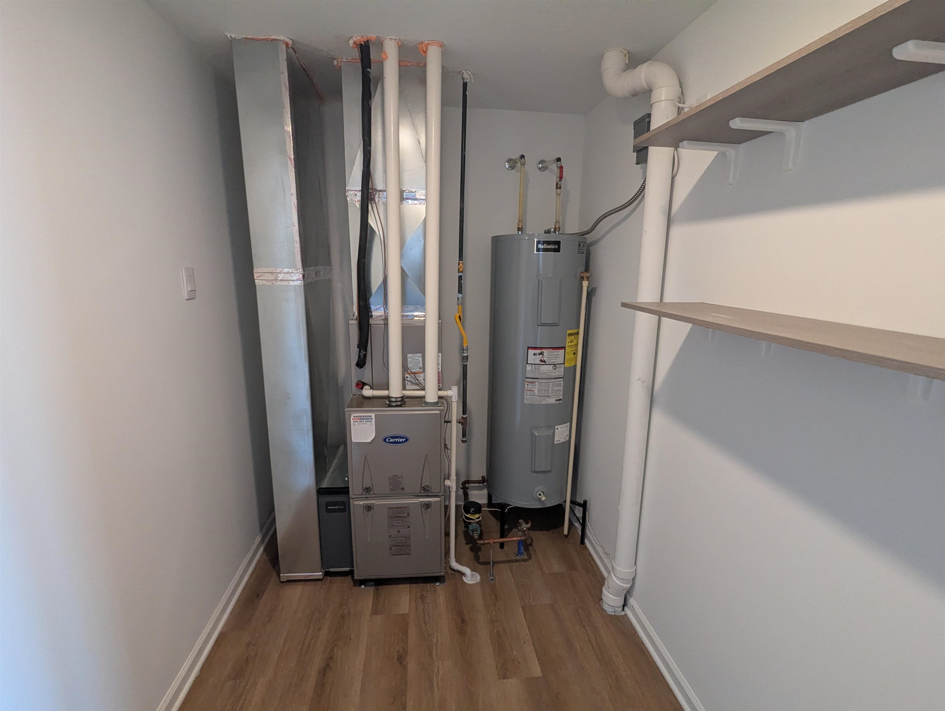 Utility room with water heater and heating unit