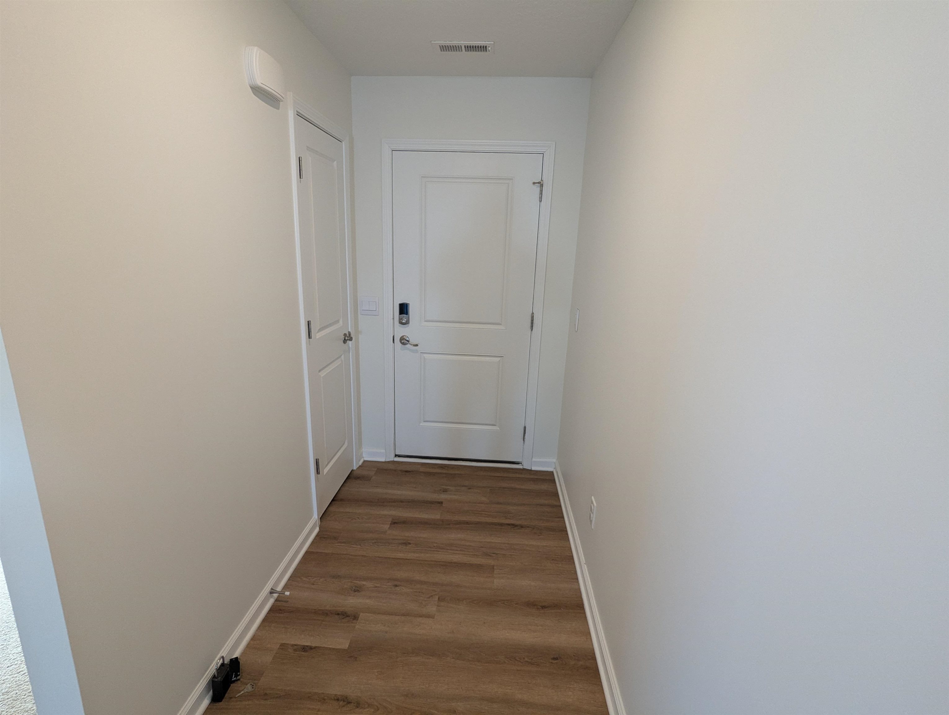 Corridor with light wood finished floors and baseboards