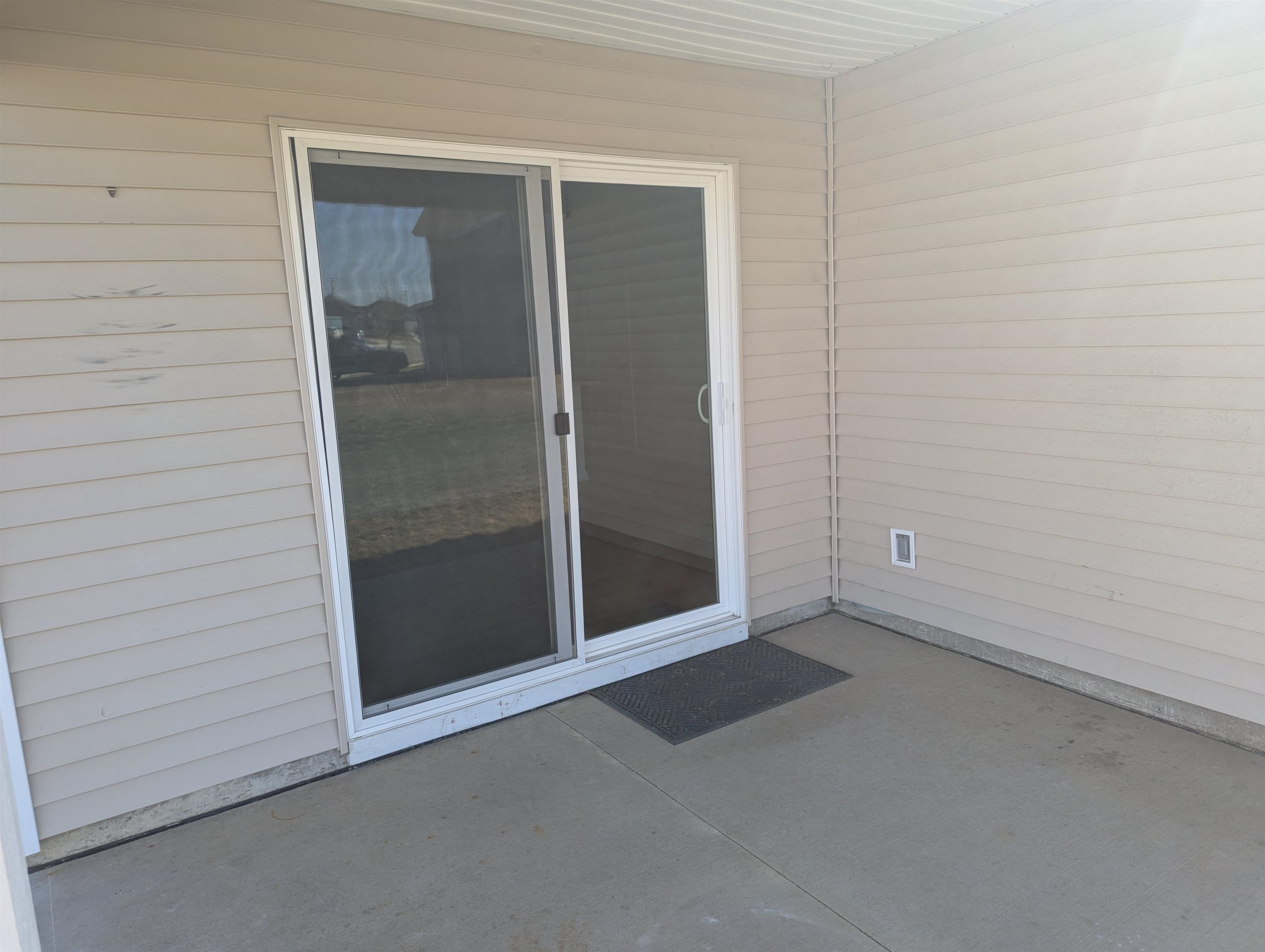 Doorway to property with a patio area