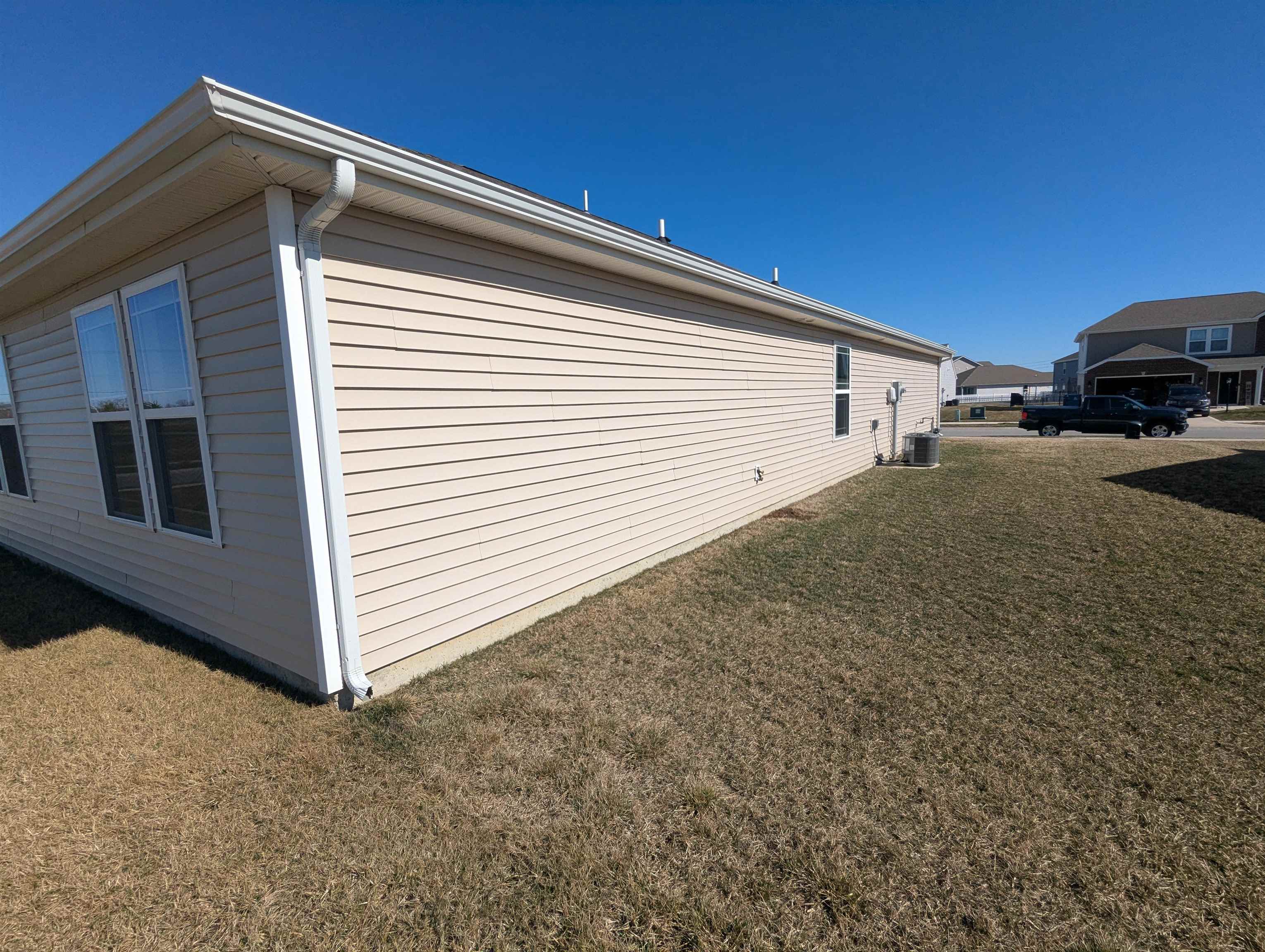 View of side of home with a lawn