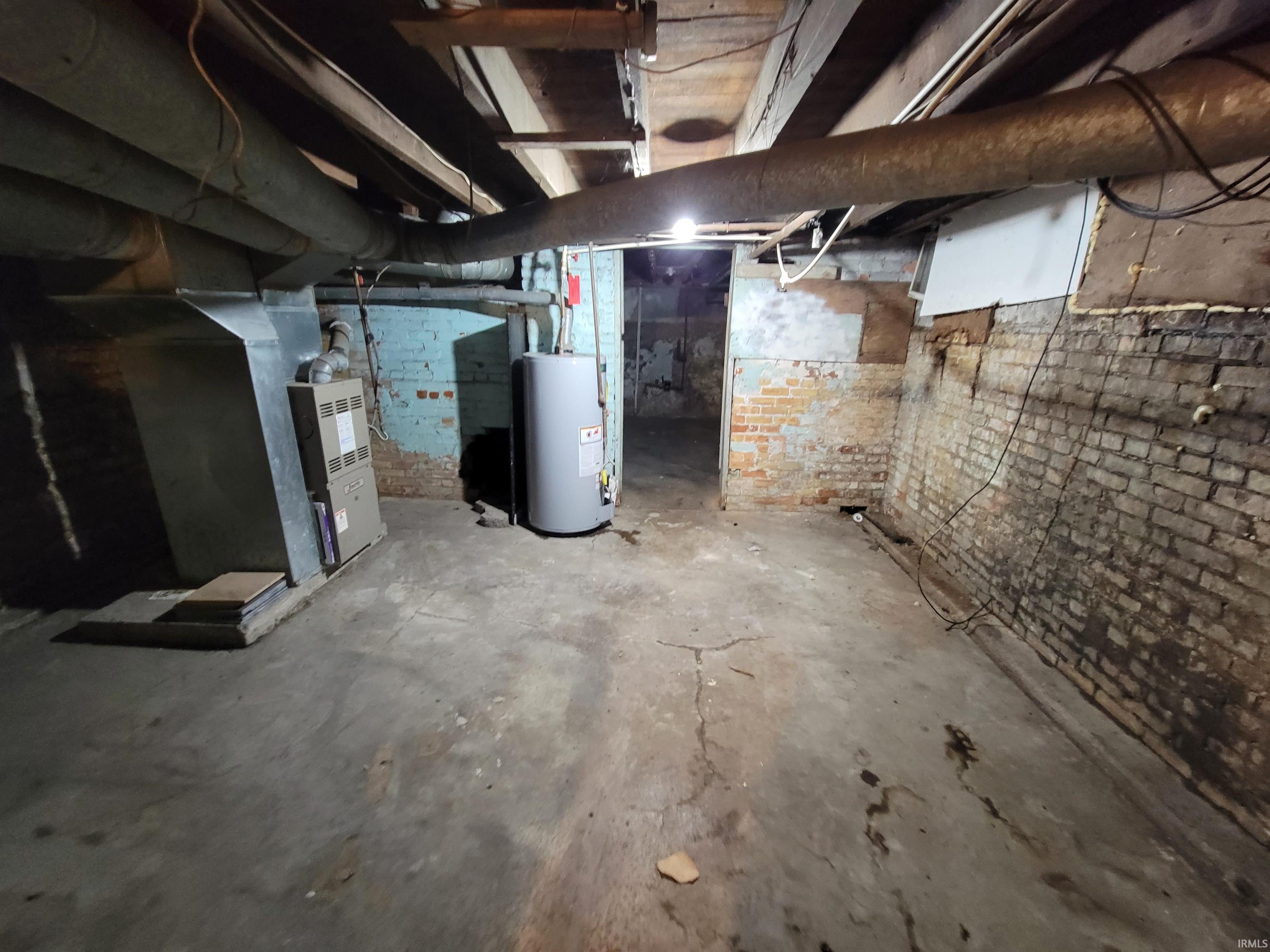 Unfinished basement with gas water heater