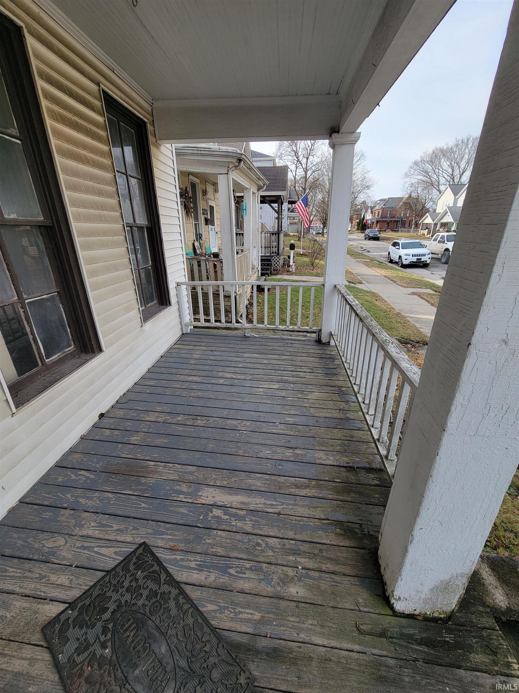 Wooden porch featuring a residential view