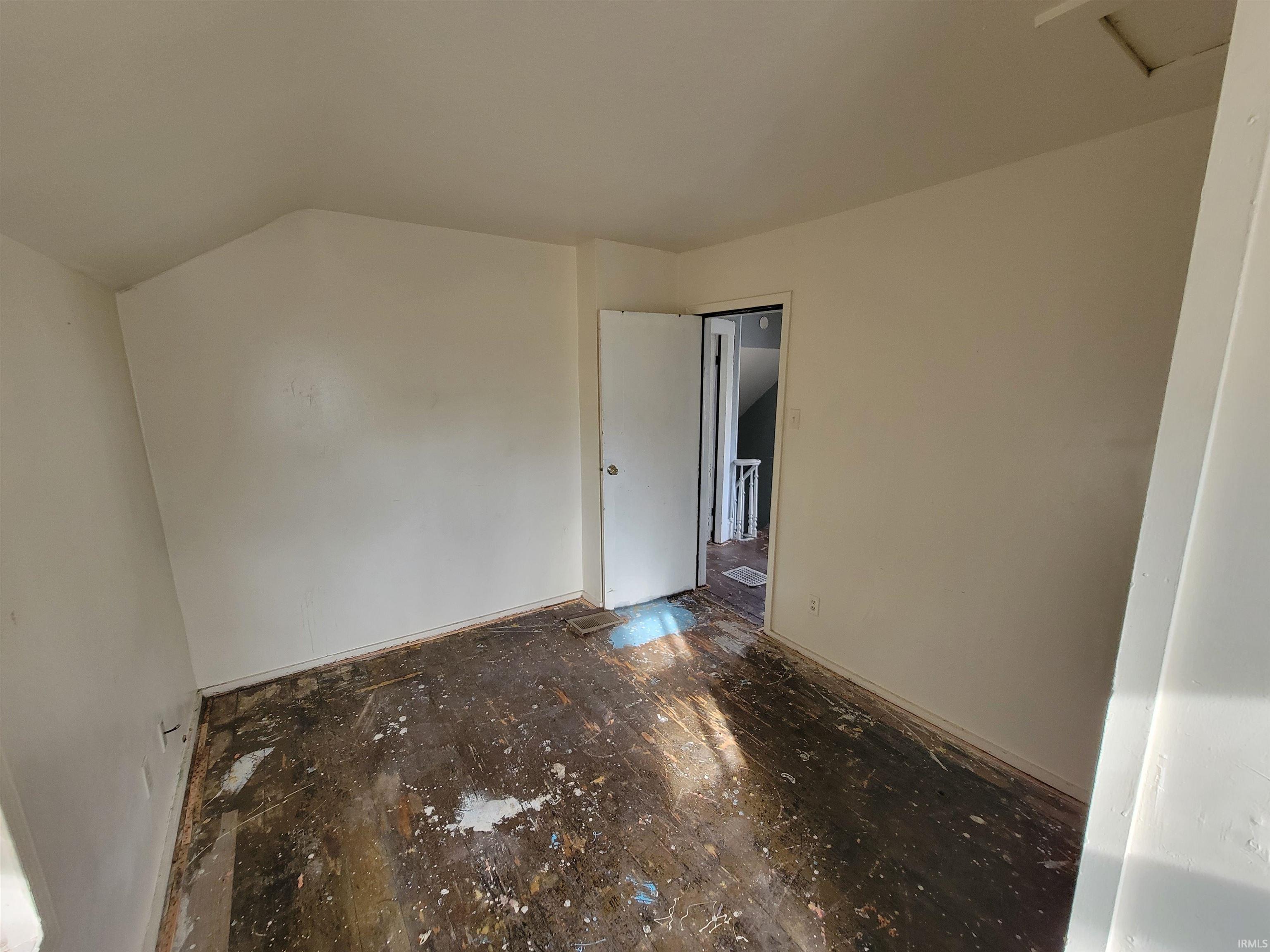 Empty room with lofted ceiling