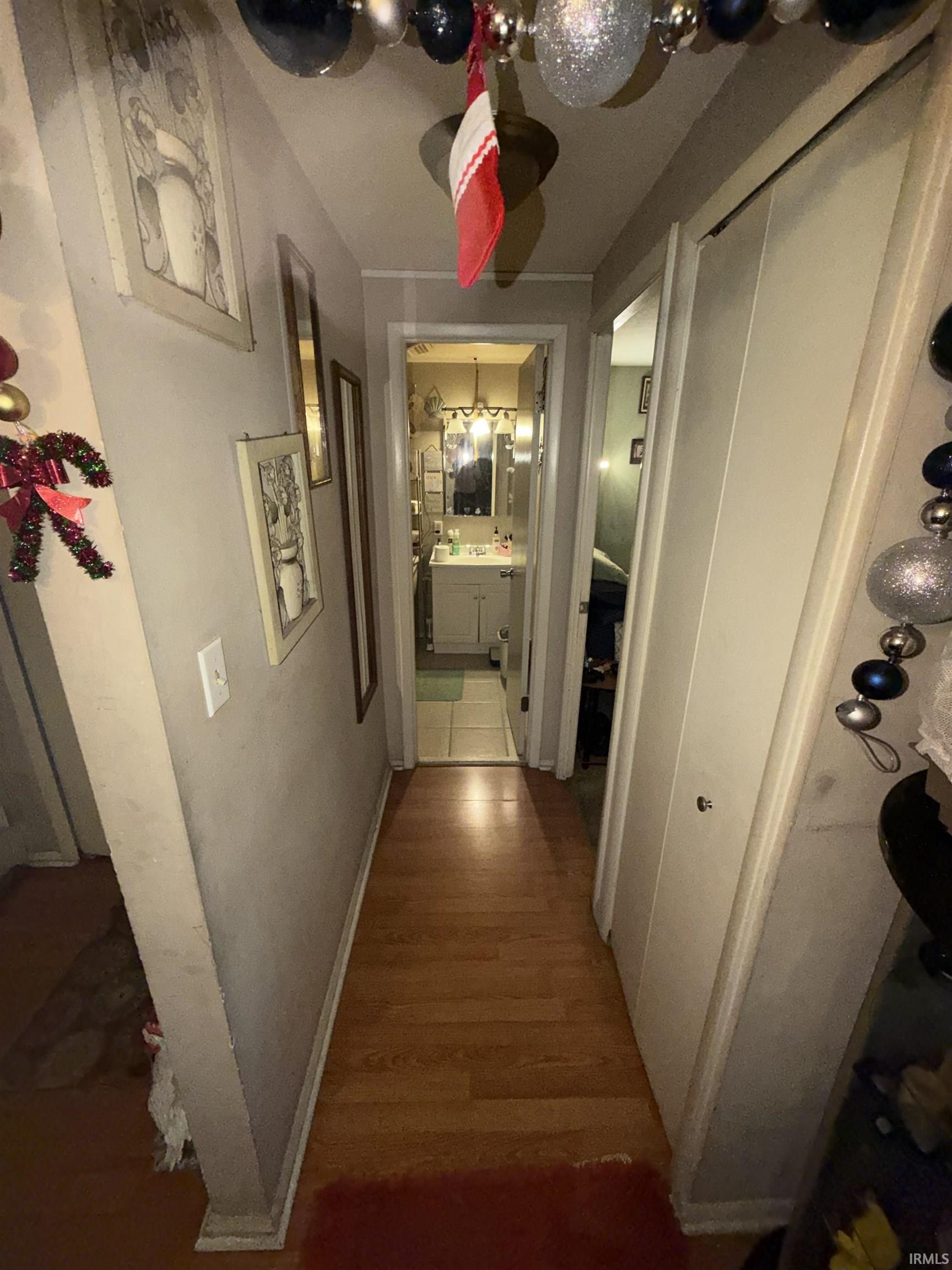 Hall with wood finished floors and baseboards