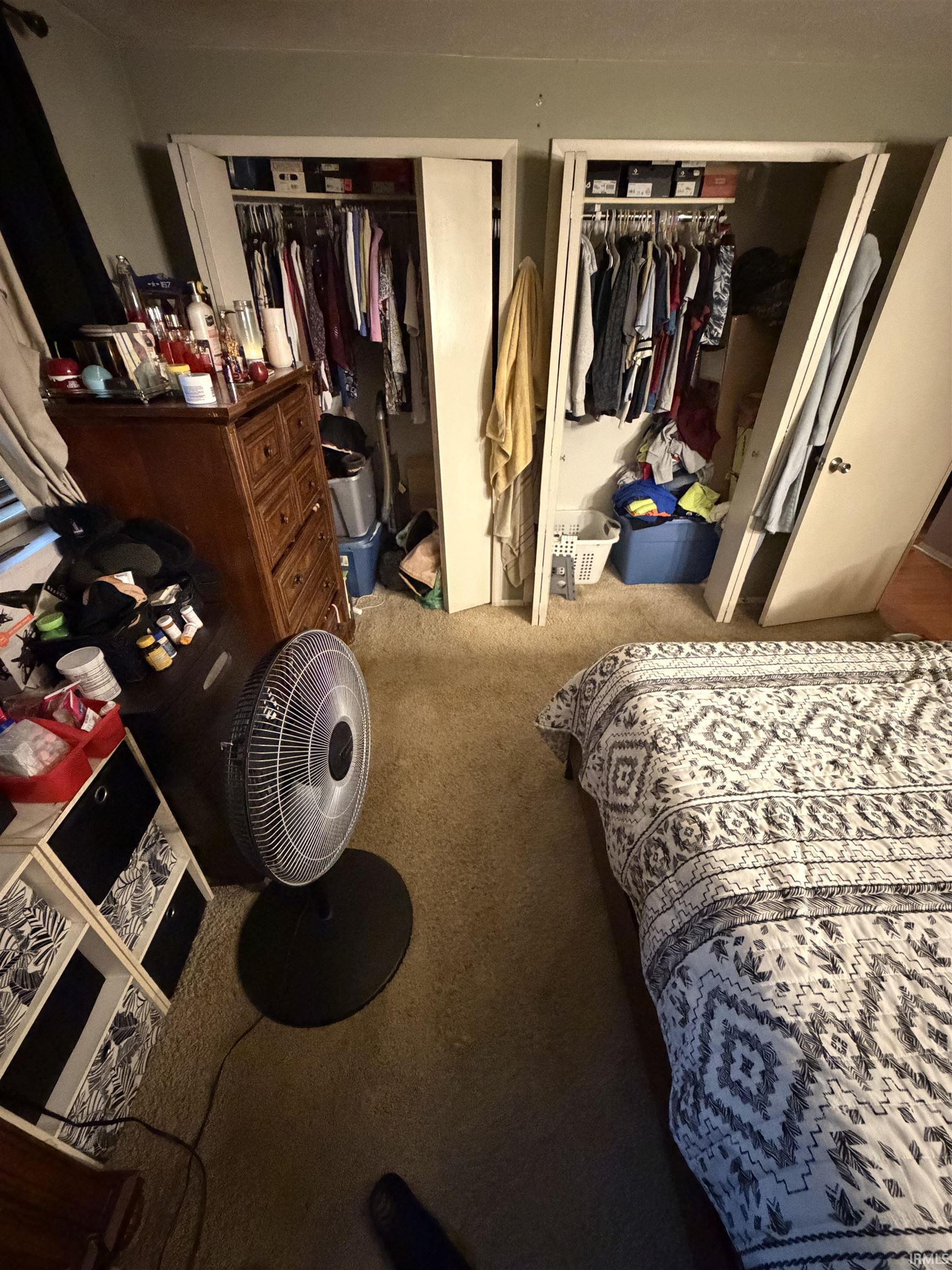 Carpeted bedroom with two closets