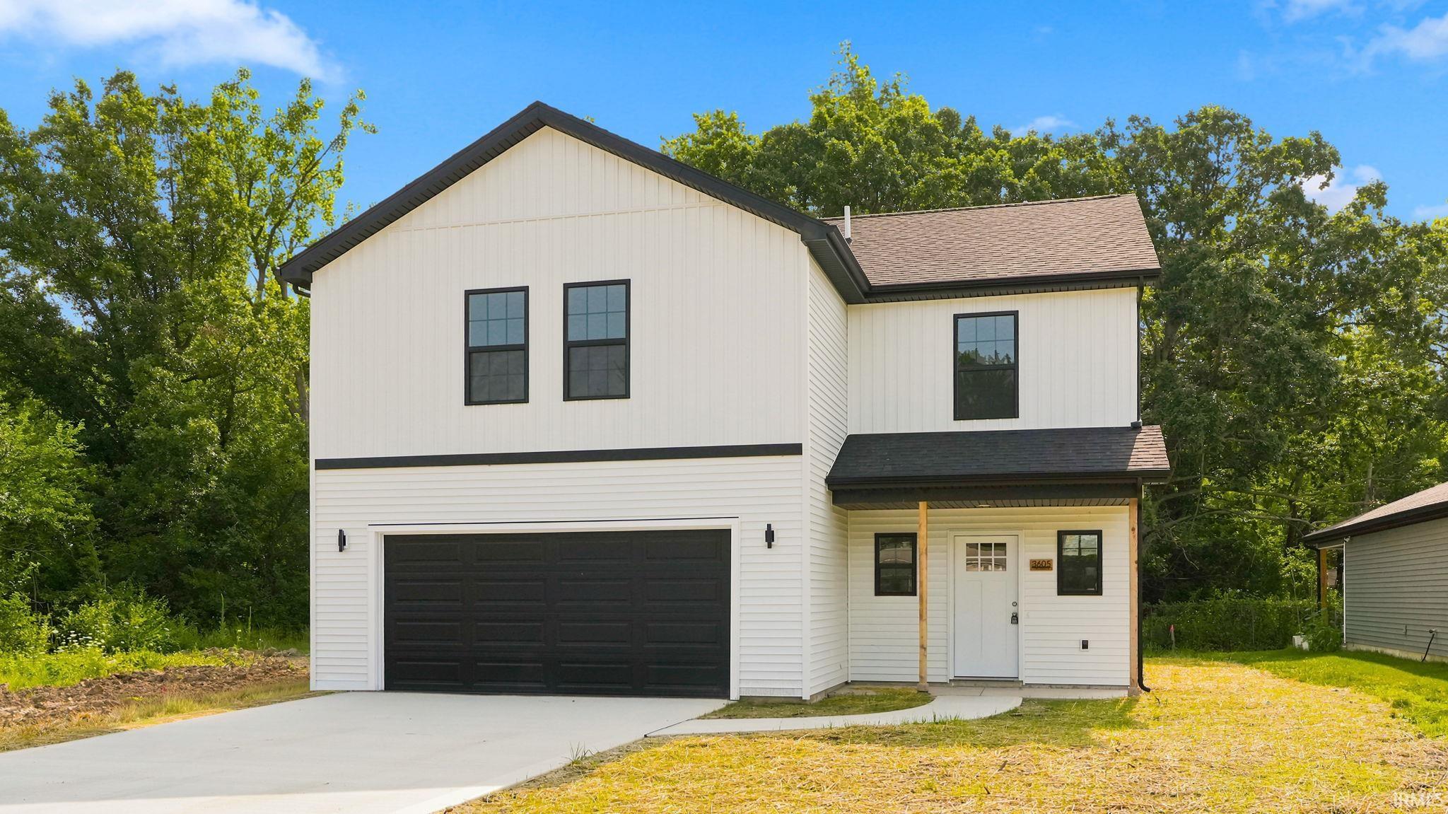 Contemporary exterior with white siding and black trim accents