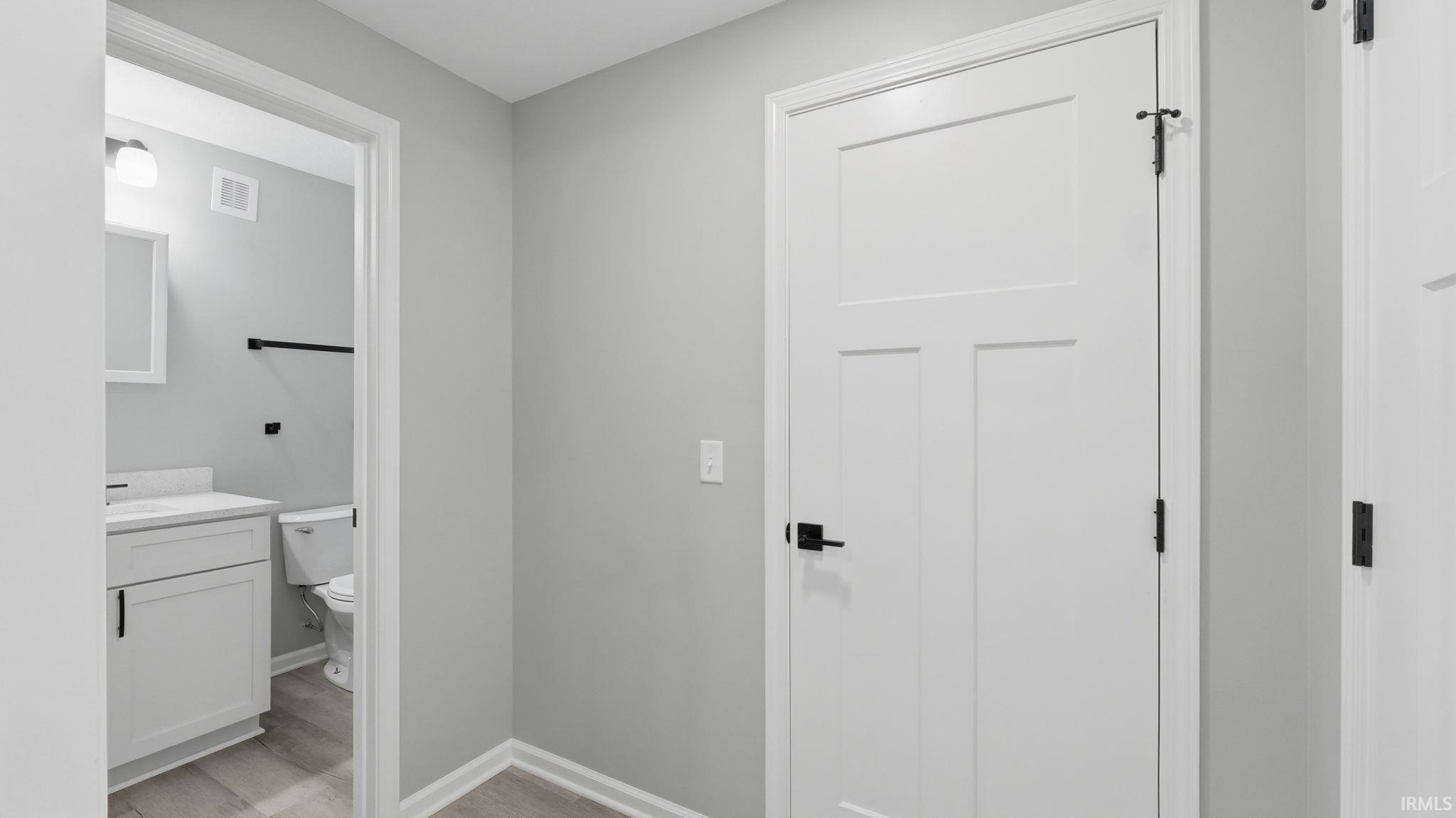 White three-panel interior door with matte black hardware