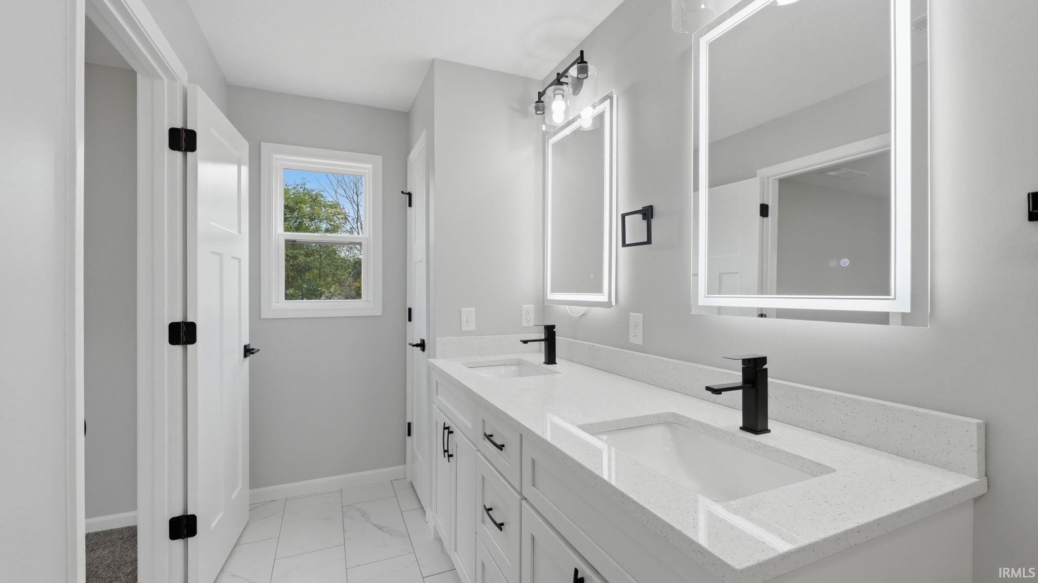 Dual vanity with integrated sinks, quartz countertops, and matte black fixtures
