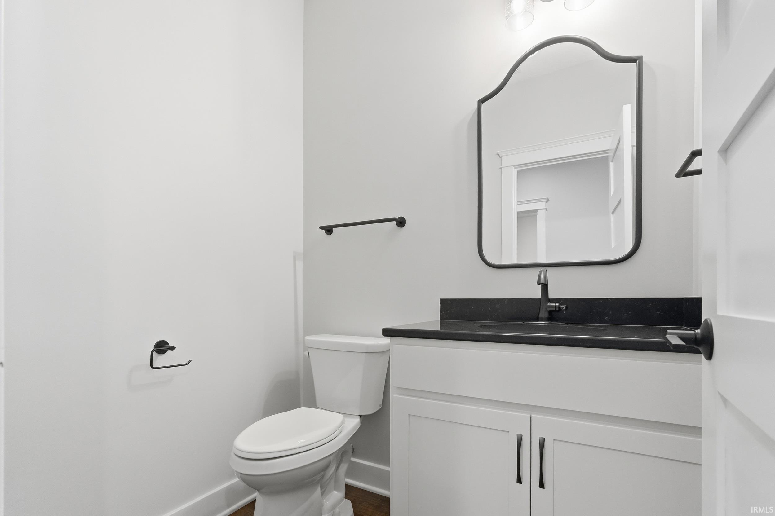 Half bath featuring vanity and toilet