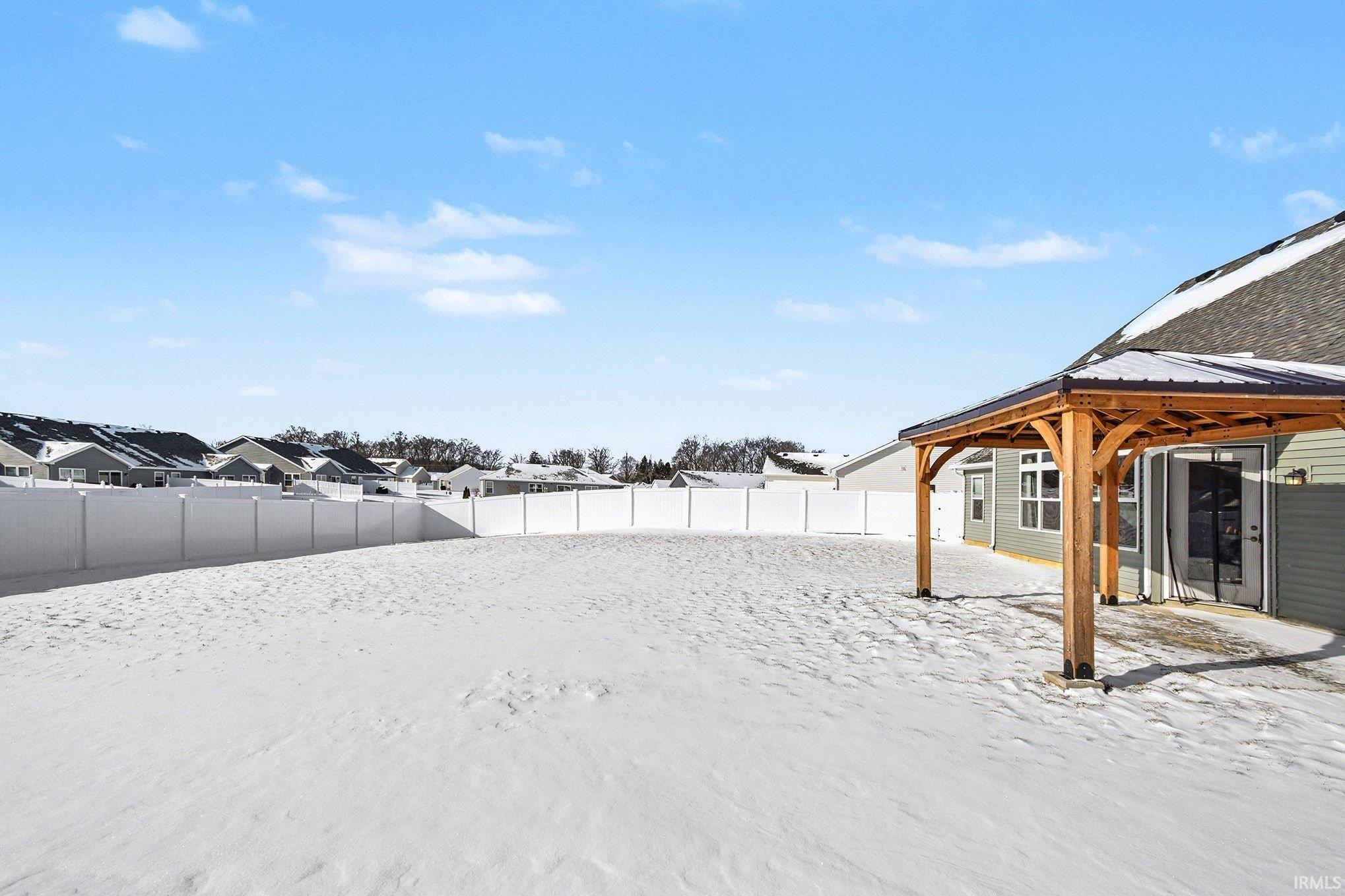 Fenced backyard featuring a residential view and a patio