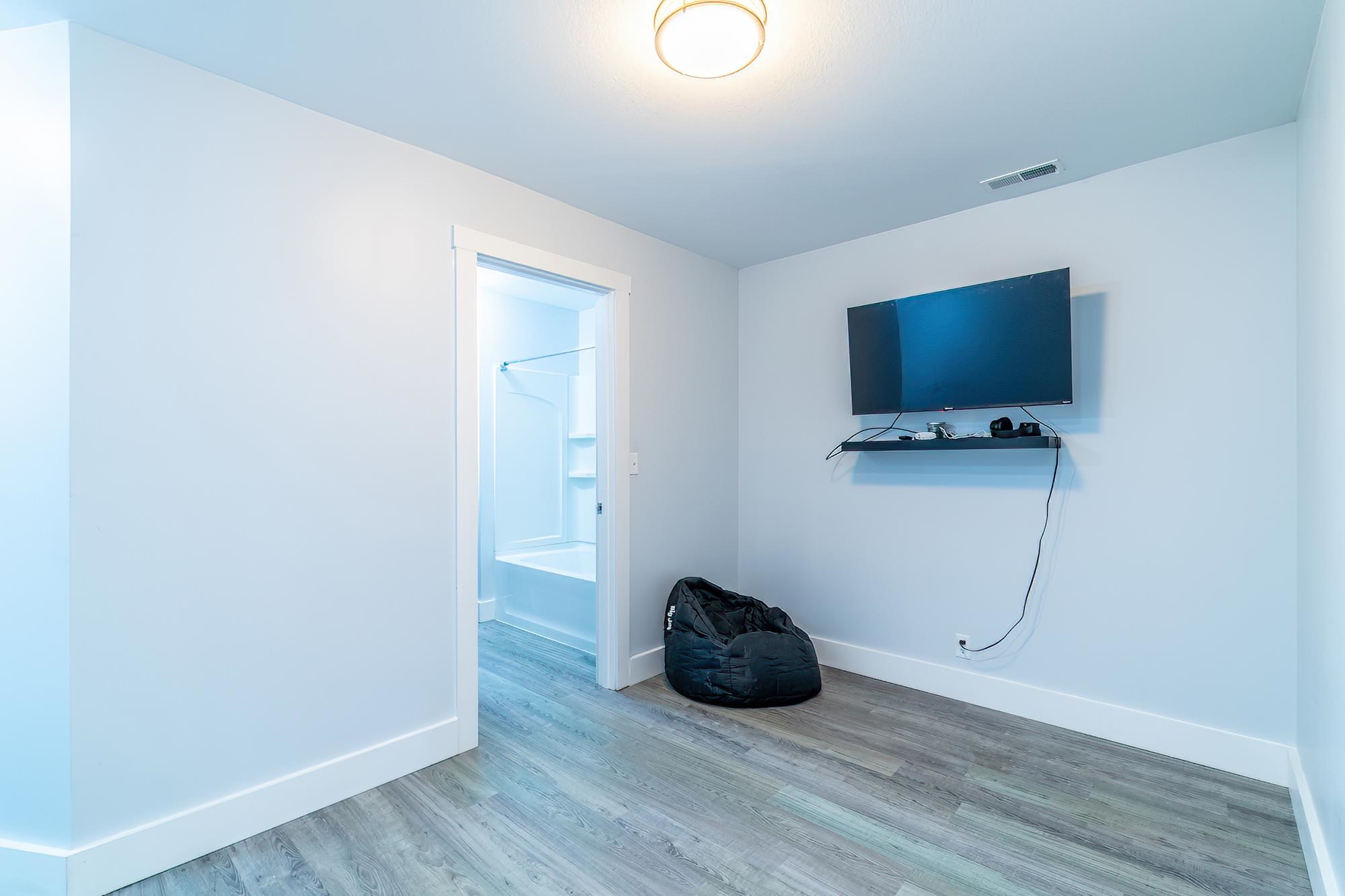 Spare room featuring baseboards and wood finished floors