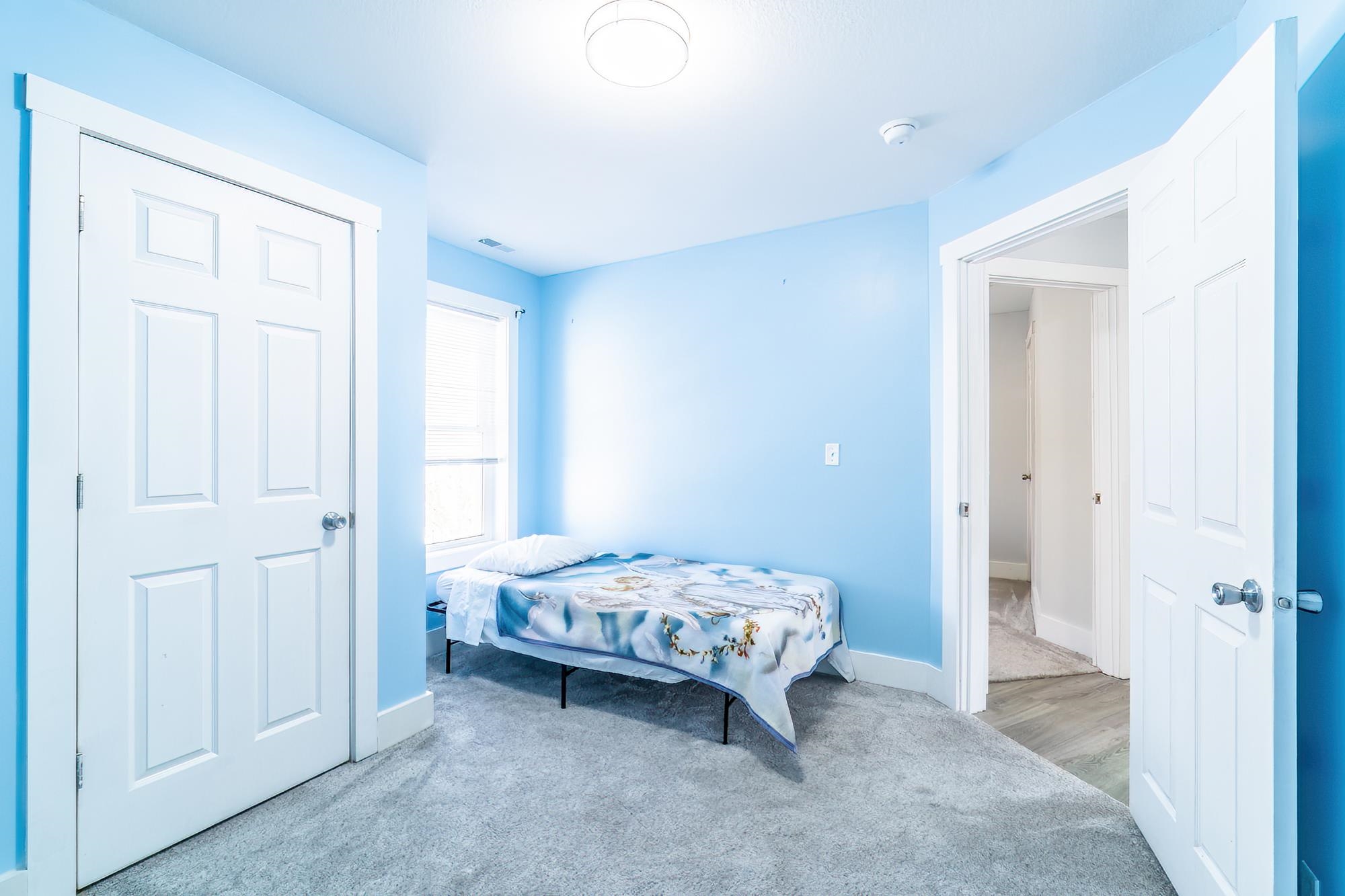 Bedroom with carpet flooring and baseboards