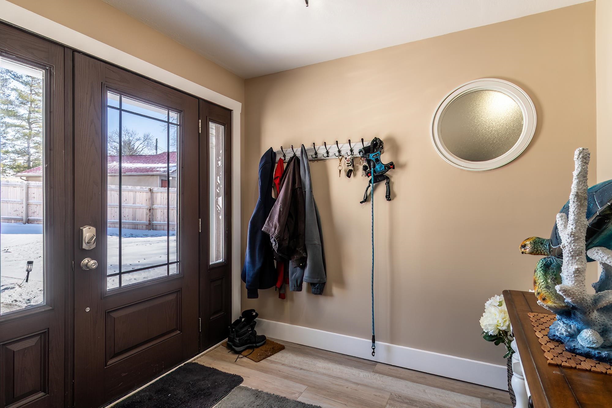 Doorway to outside with baseboards and wood finished floors