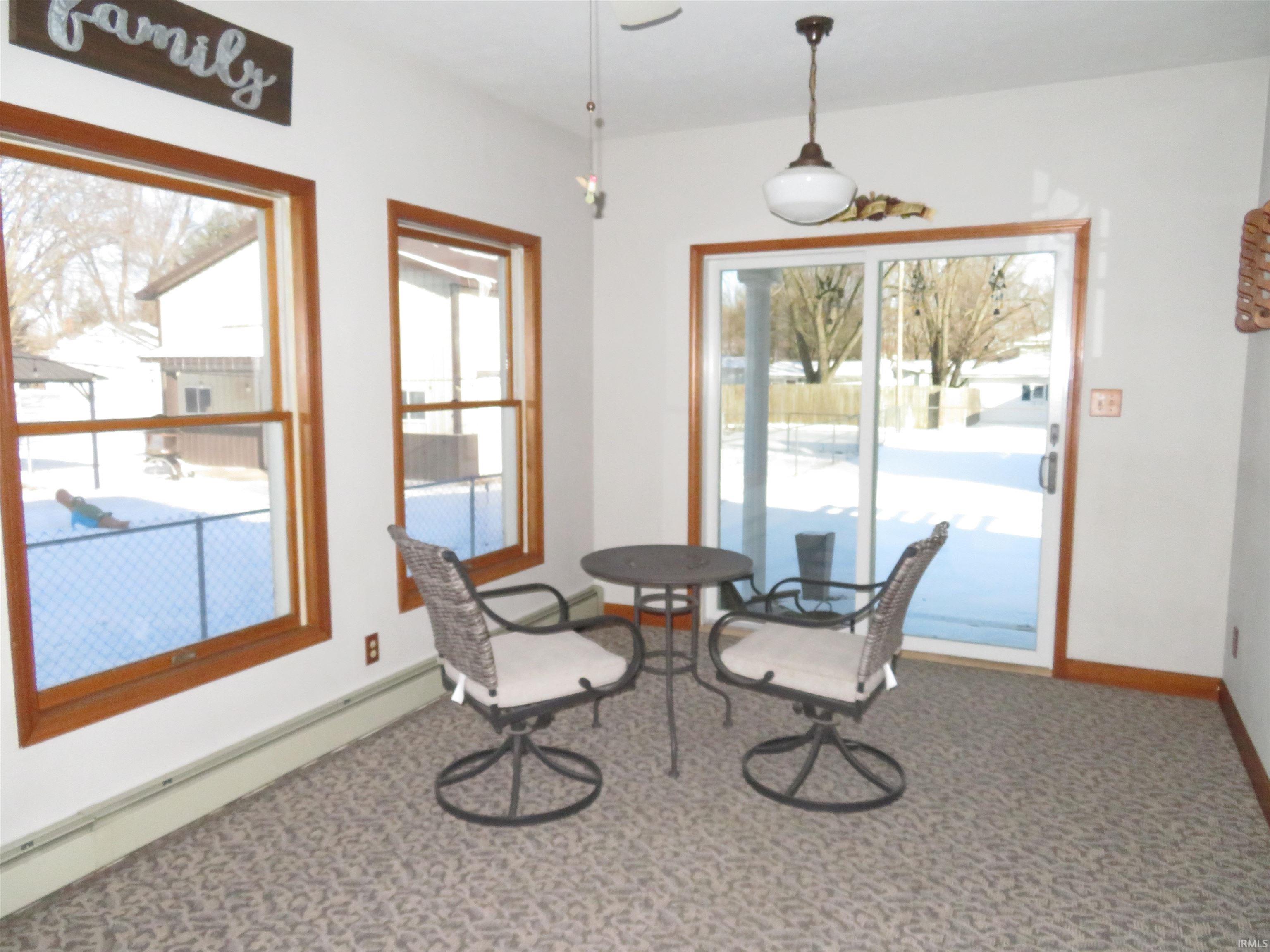 Sunroom overlooks backyard.