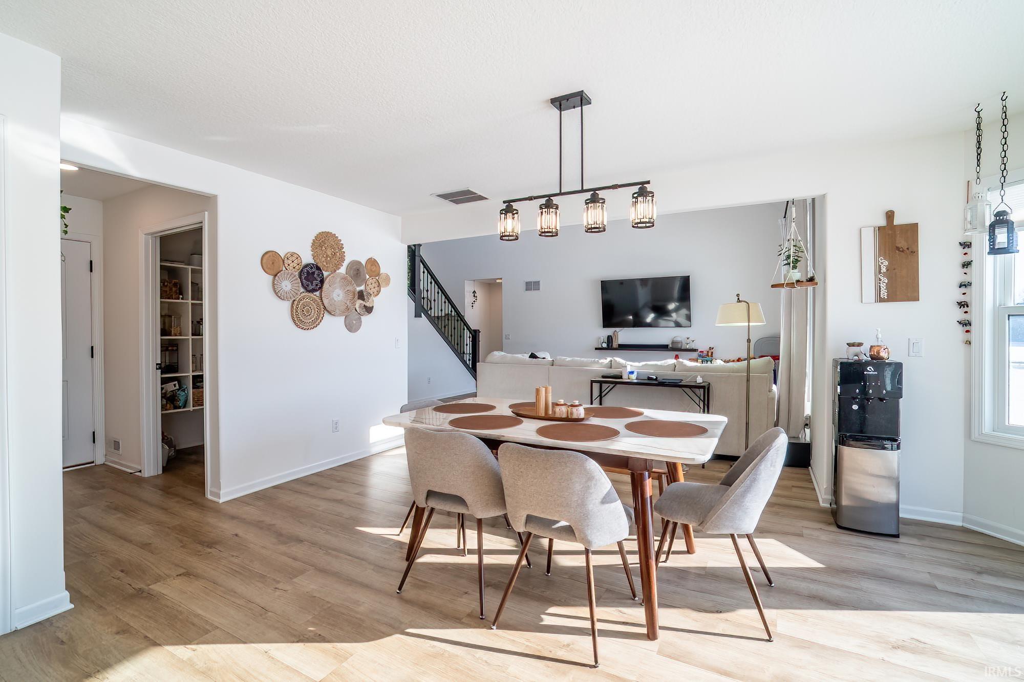 Dining area featuring light wood-style flooring and baseboards