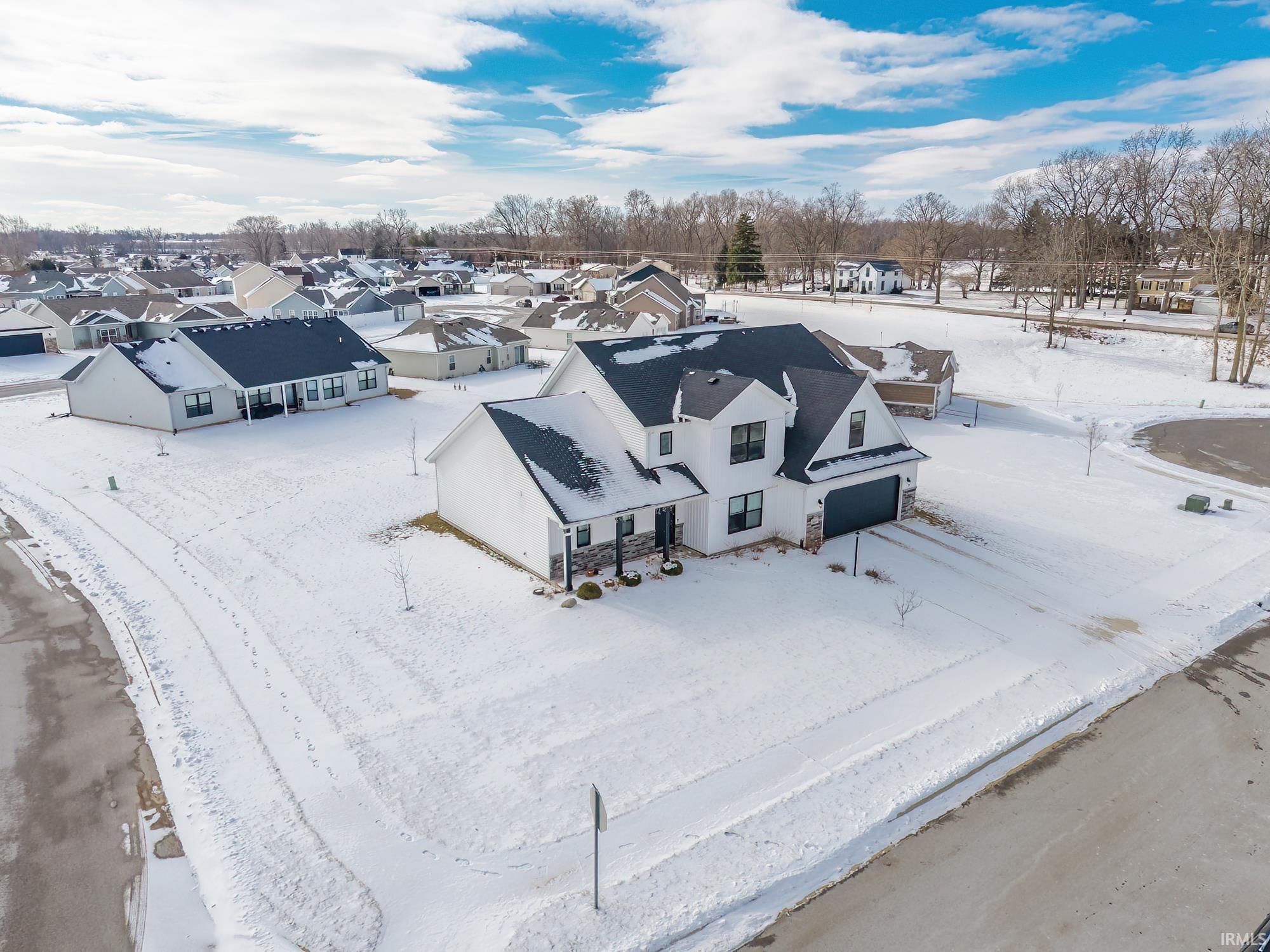 Snowy aerial view featuring a residential view
