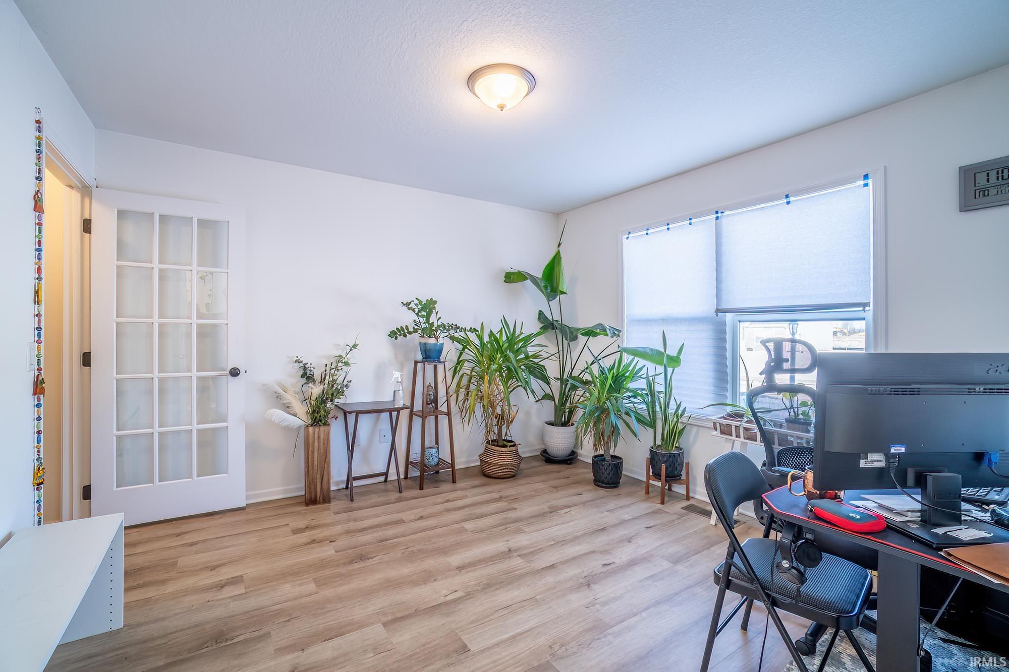 Office with wood finished floors and baseboards