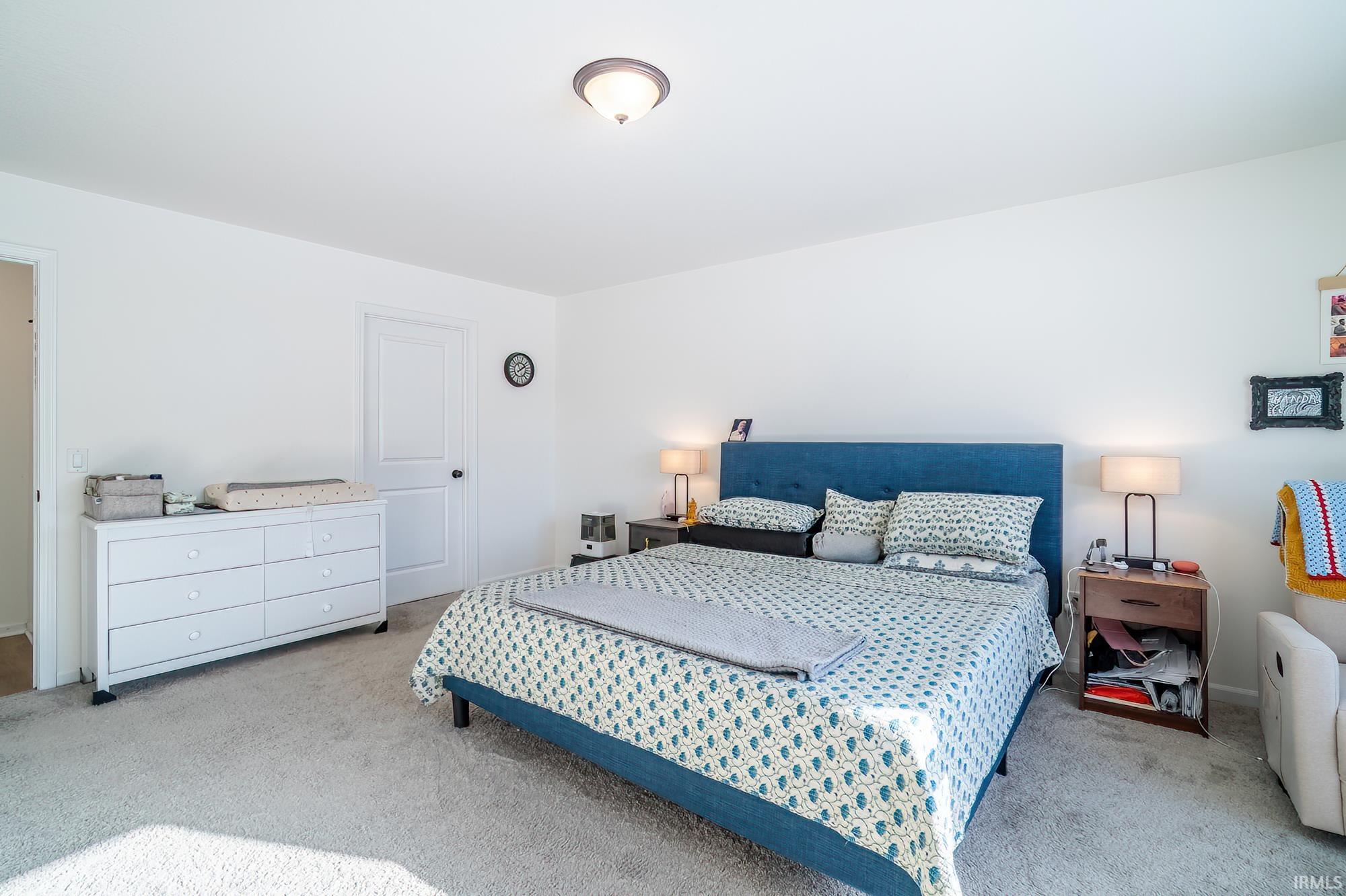 Carpeted bedroom with baseboards