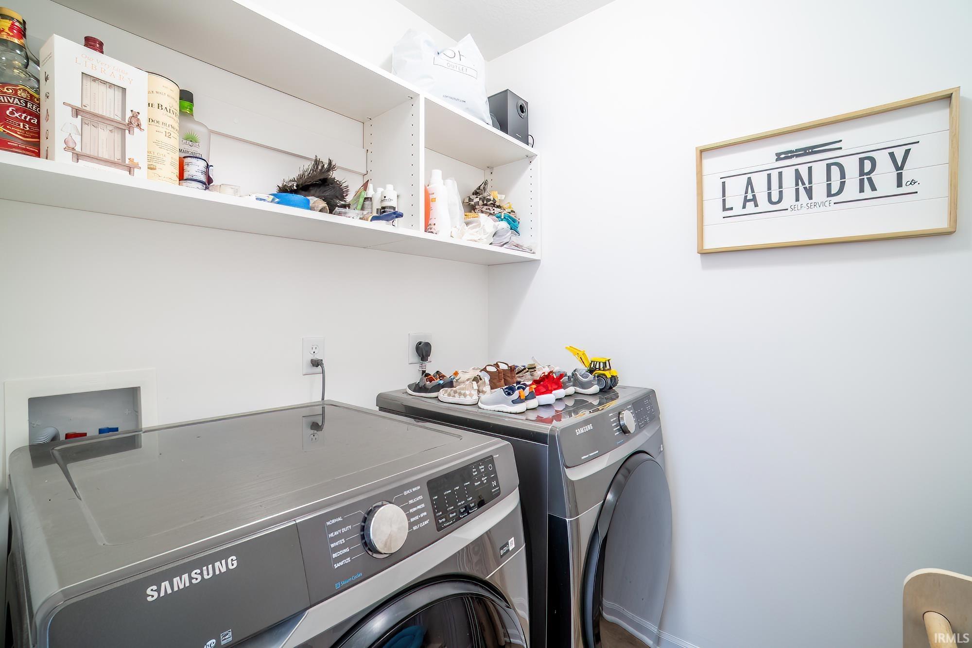 Washroom with washer and clothes dryer