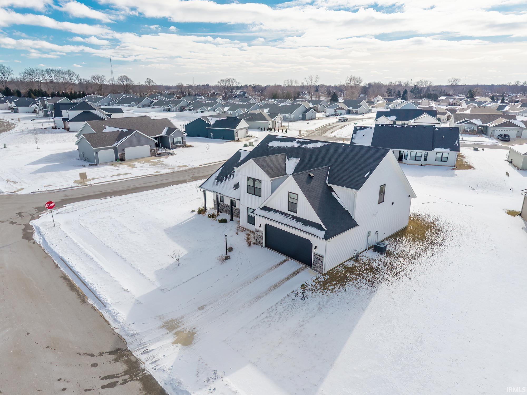 Snowy aerial view featuring a residential view