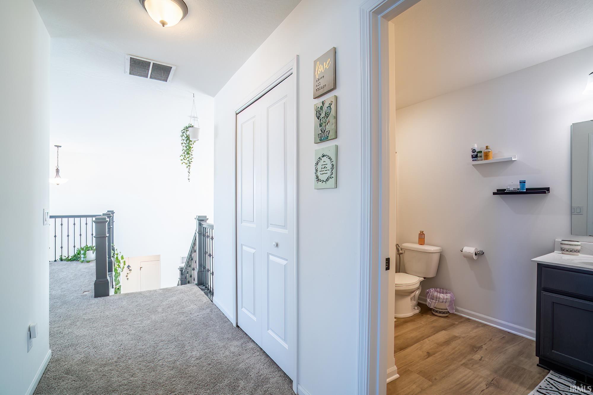 Hallway with an upstairs landing and baseboards