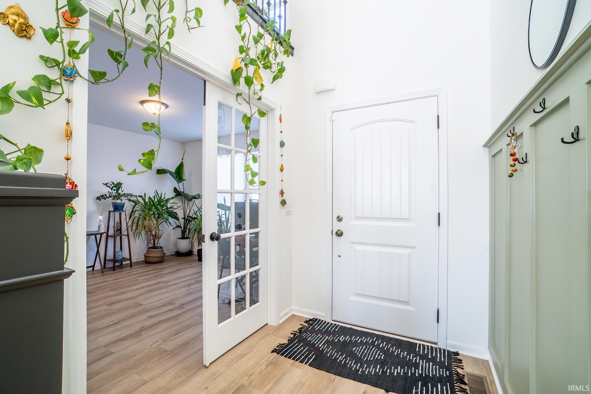 Entrance foyer featuring wood finished floors and baseboards