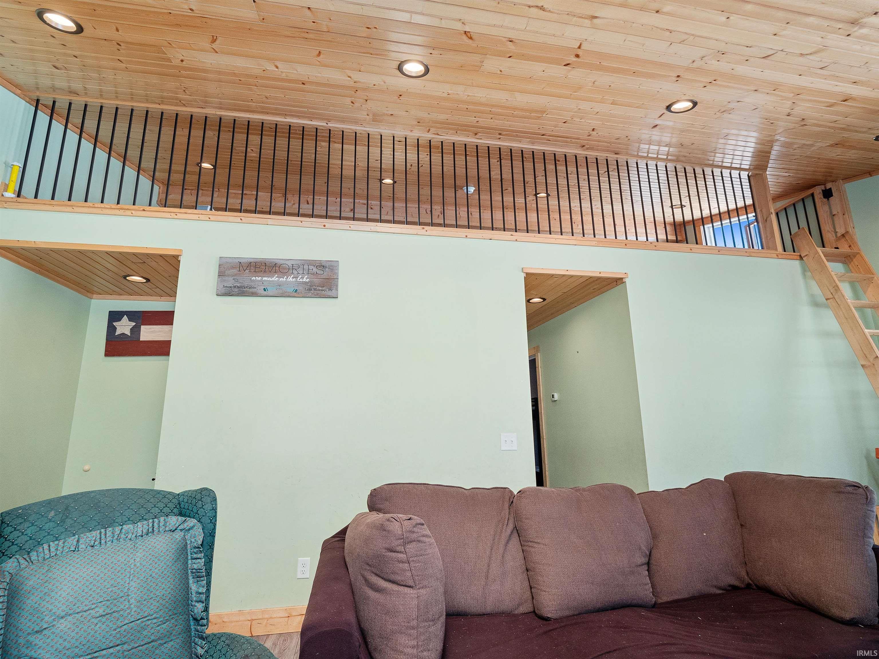 Living room with wooden ceiling and recessed lighting