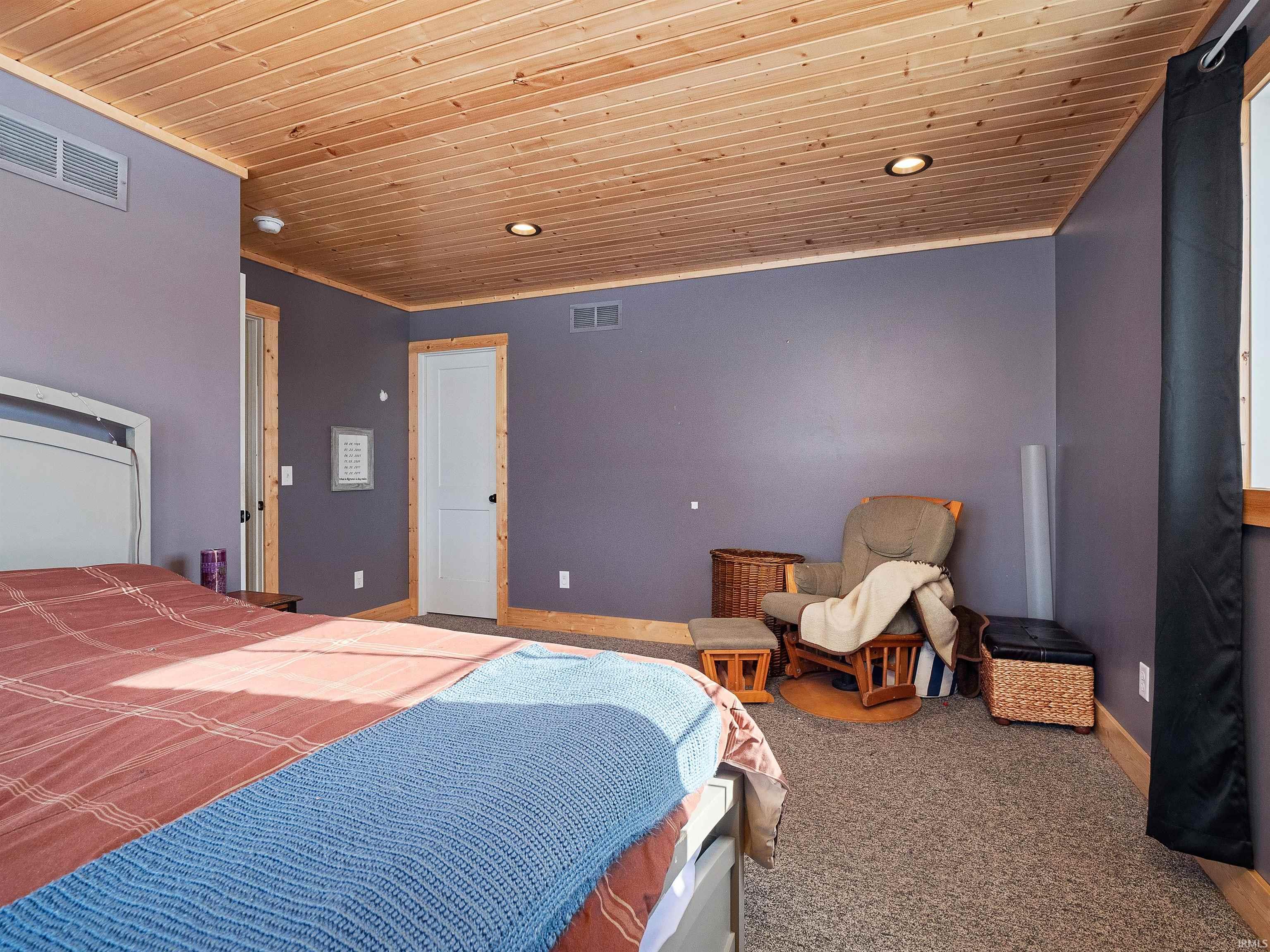 Carpeted bedroom with wood ceiling, recessed lighting, and ornamental molding
