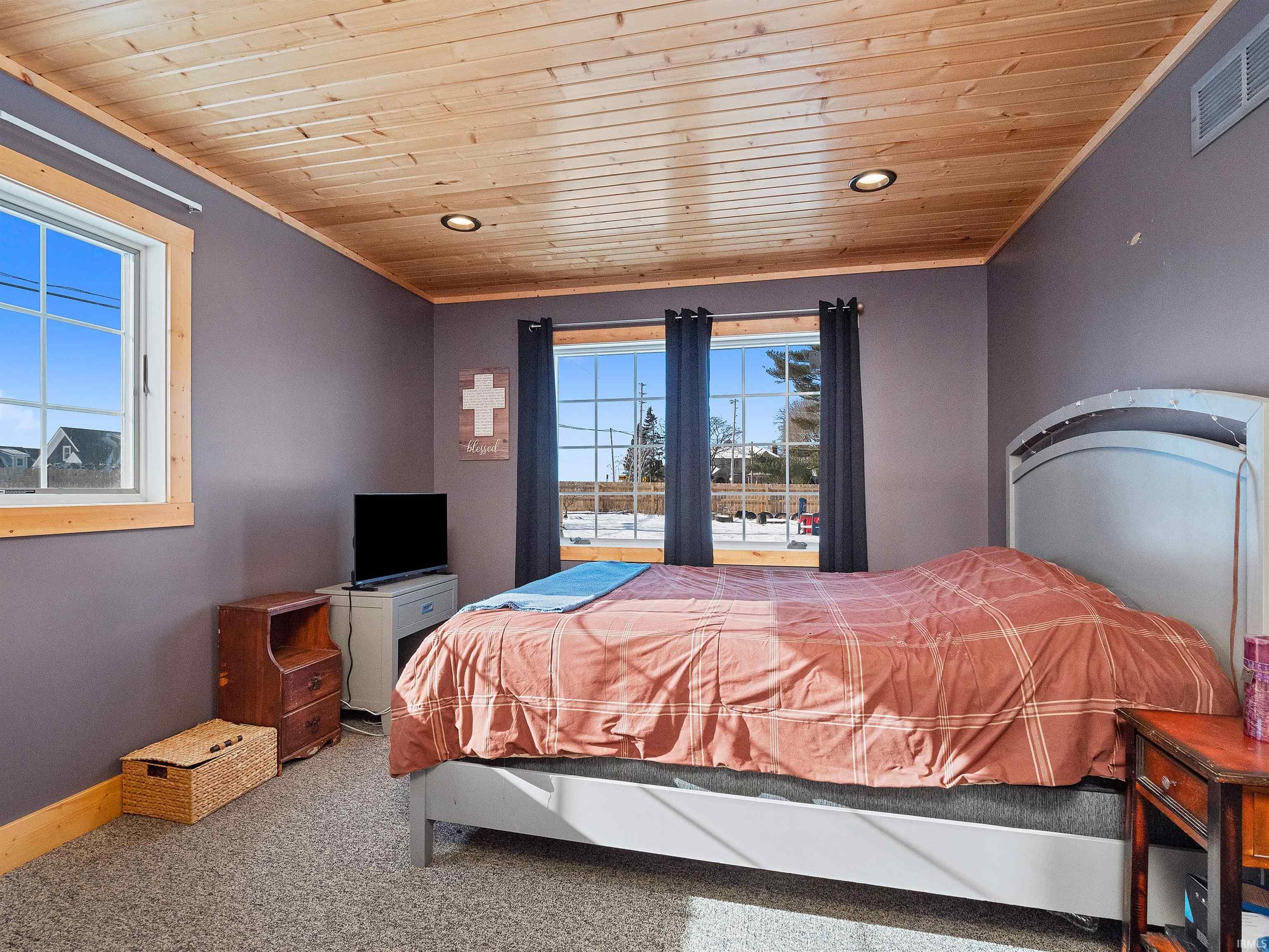 Carpeted bedroom featuring wooden ceiling, crown molding, and recessed lighting
