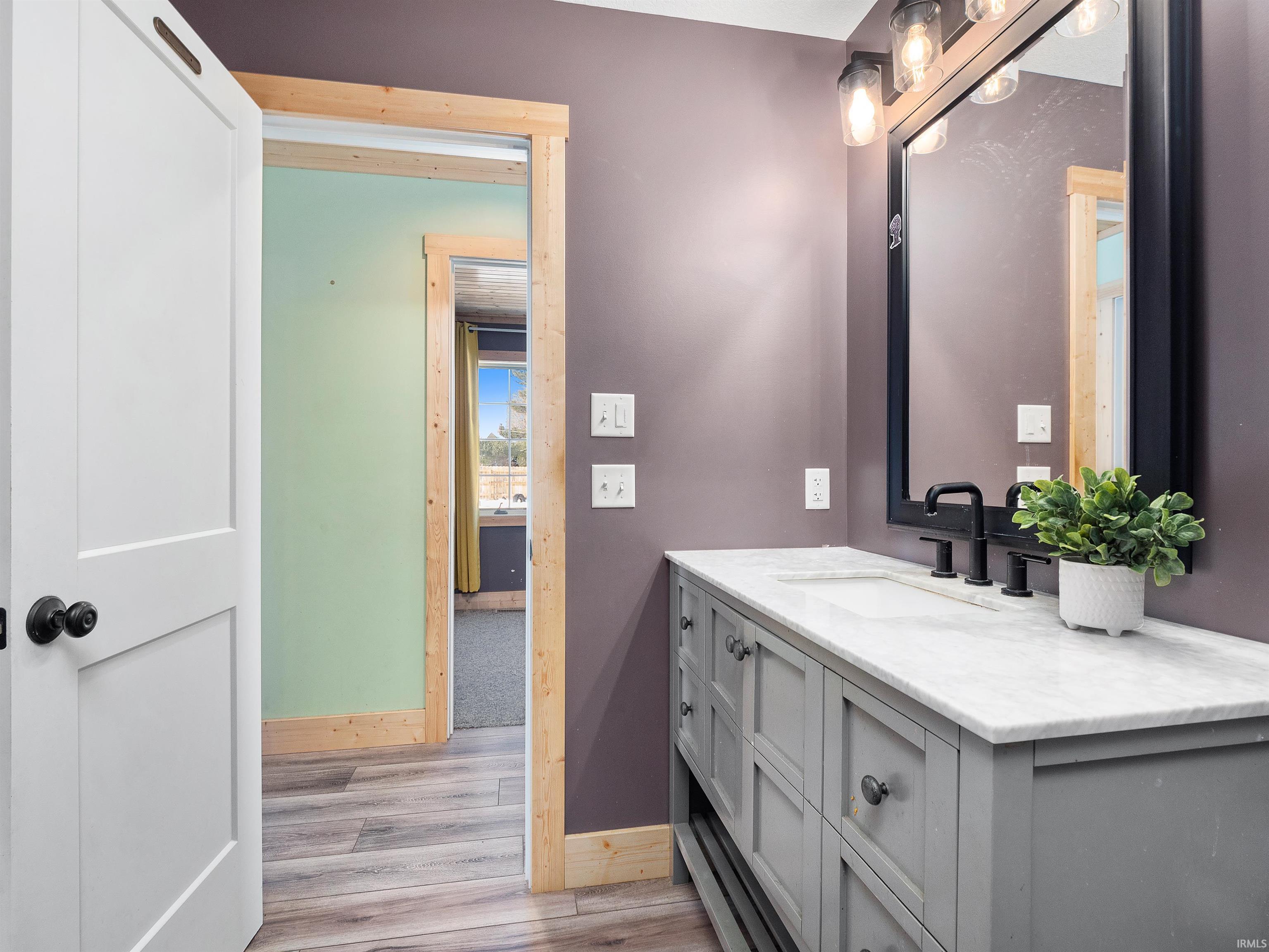 Bathroom featuring vanity and light wood finished floors