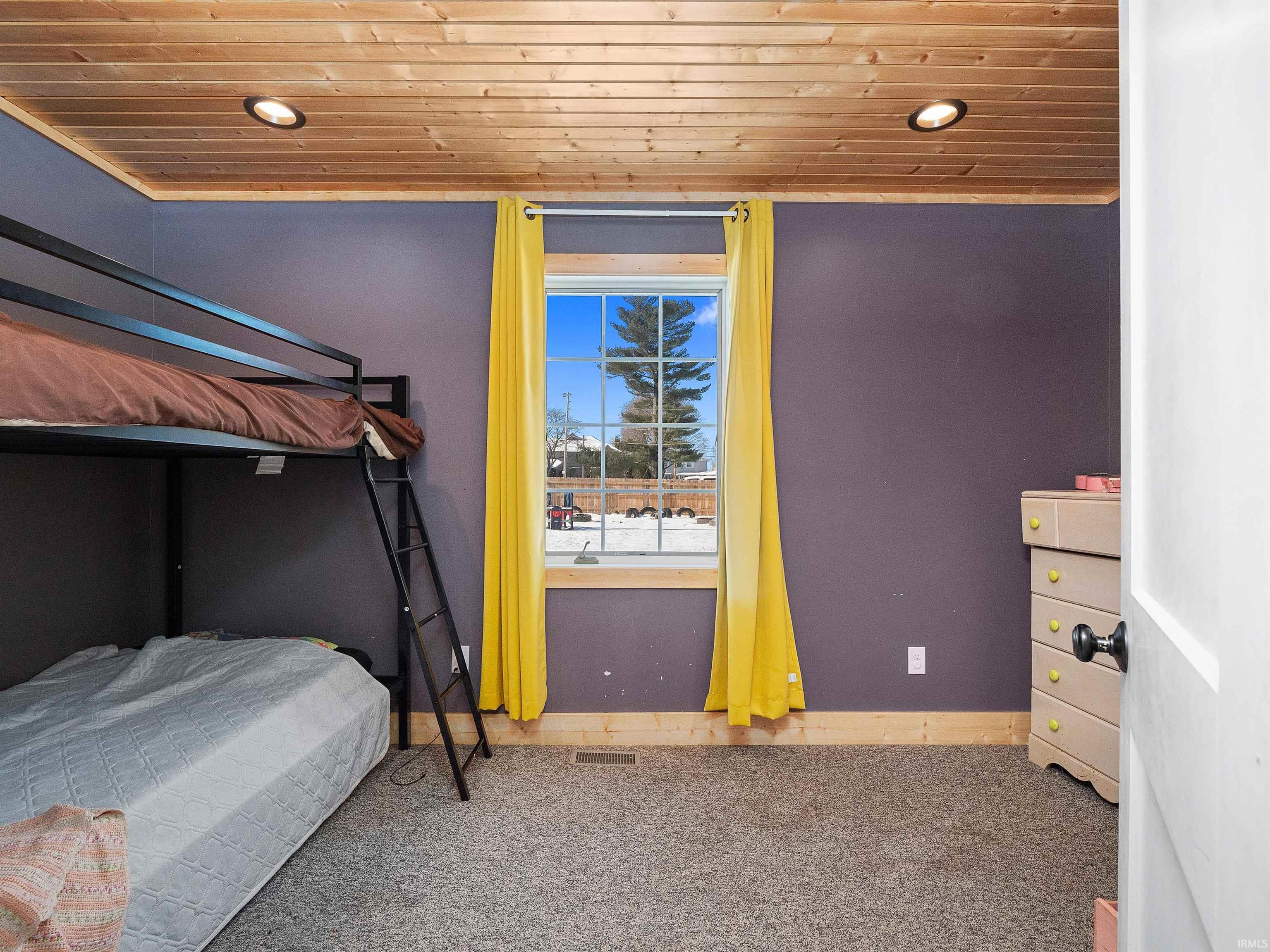 Carpeted bedroom featuring wooden ceiling and recessed lighting