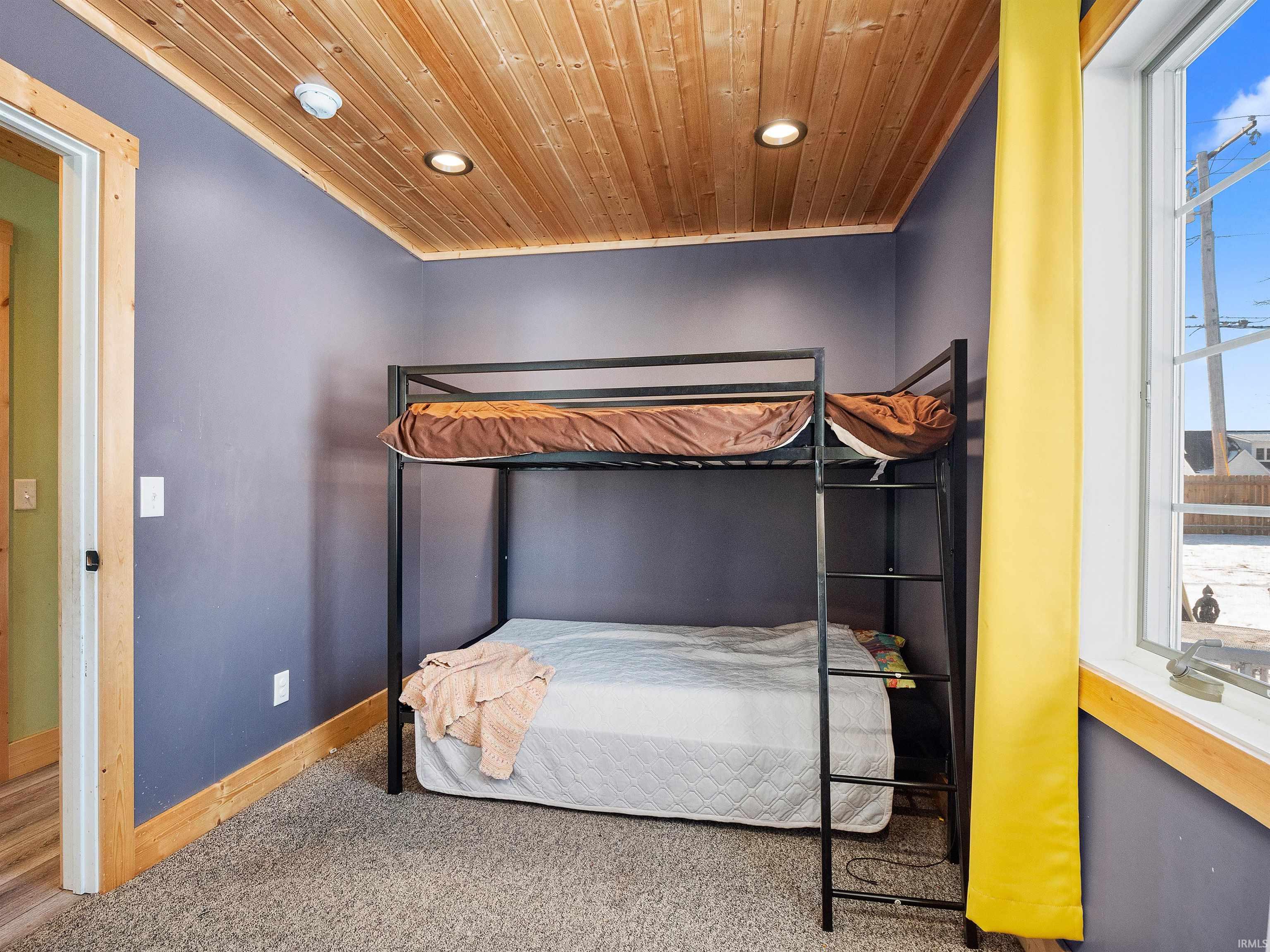 Bedroom featuring carpet floors, wooden ceiling, and recessed lighting