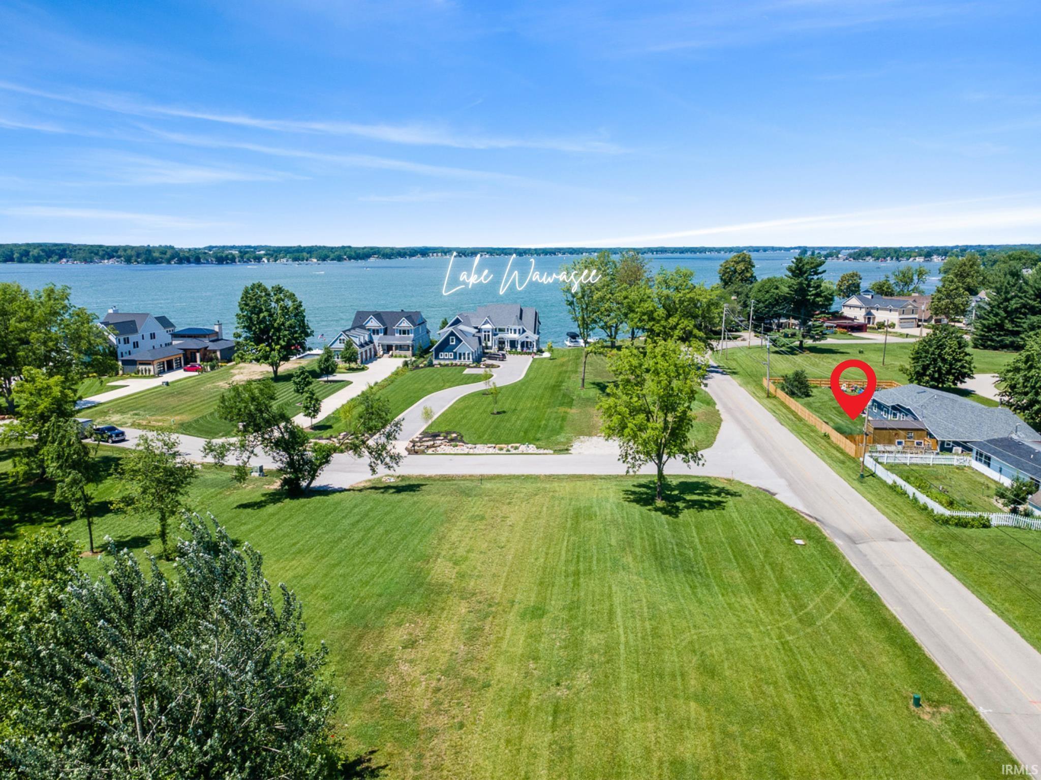 Aerial perspective of suburban area with a large body of water