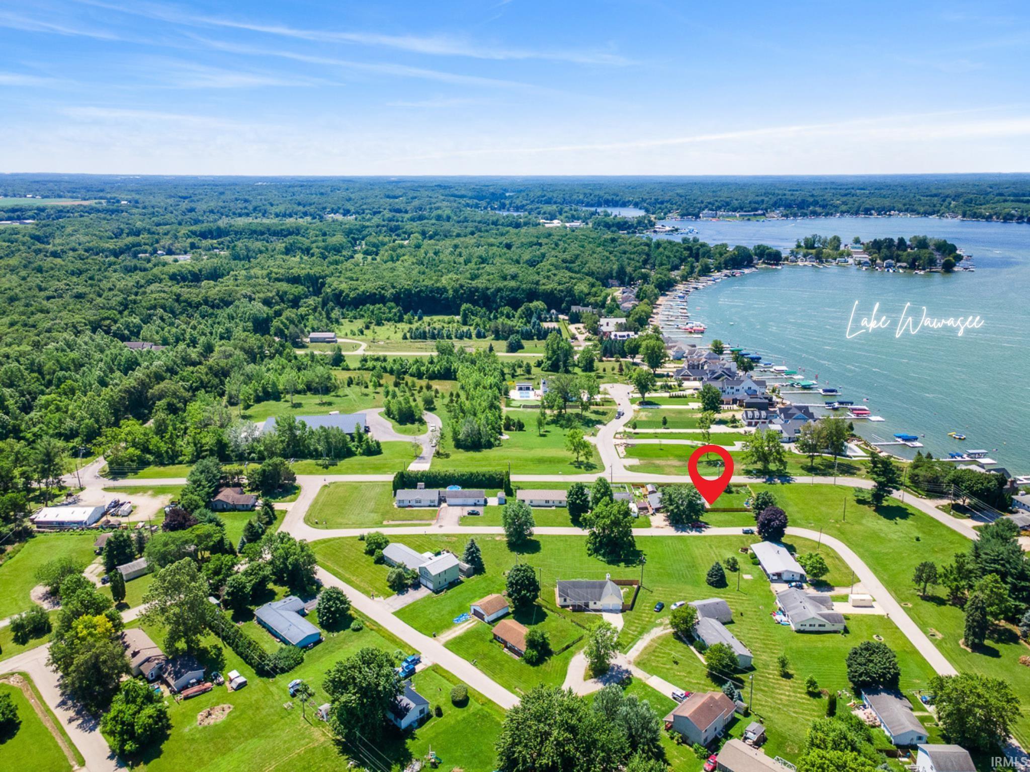 Aerial view of property and surrounding area featuring a large body of water