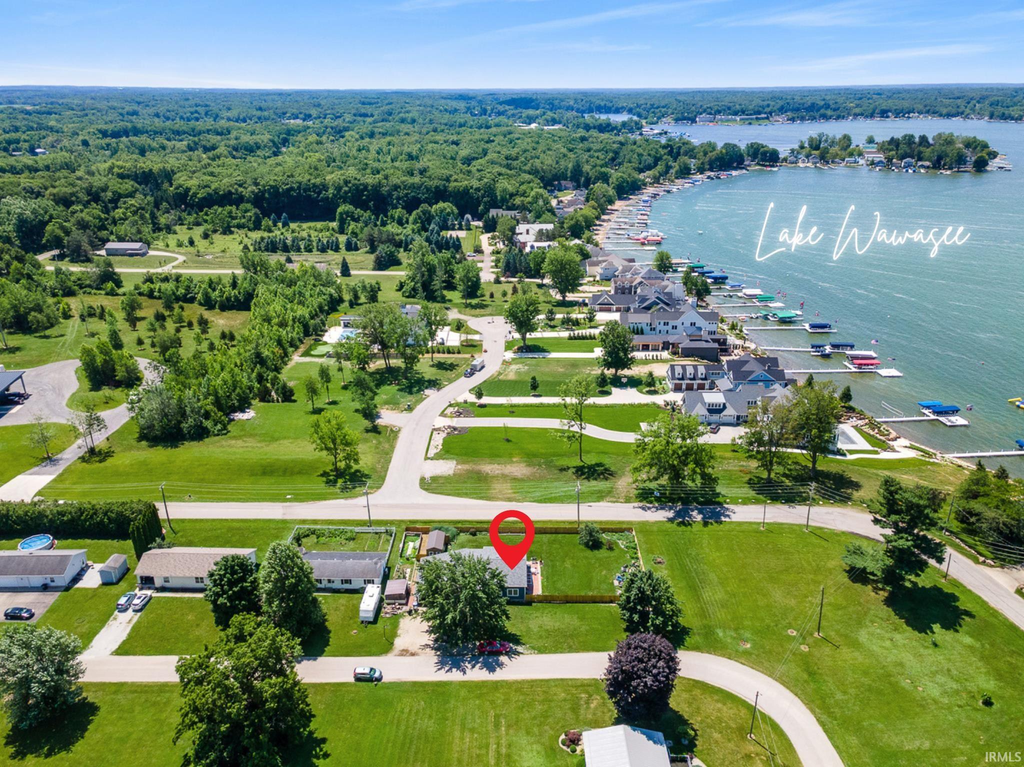 Aerial view of property and surrounding area featuring a nearby body of water