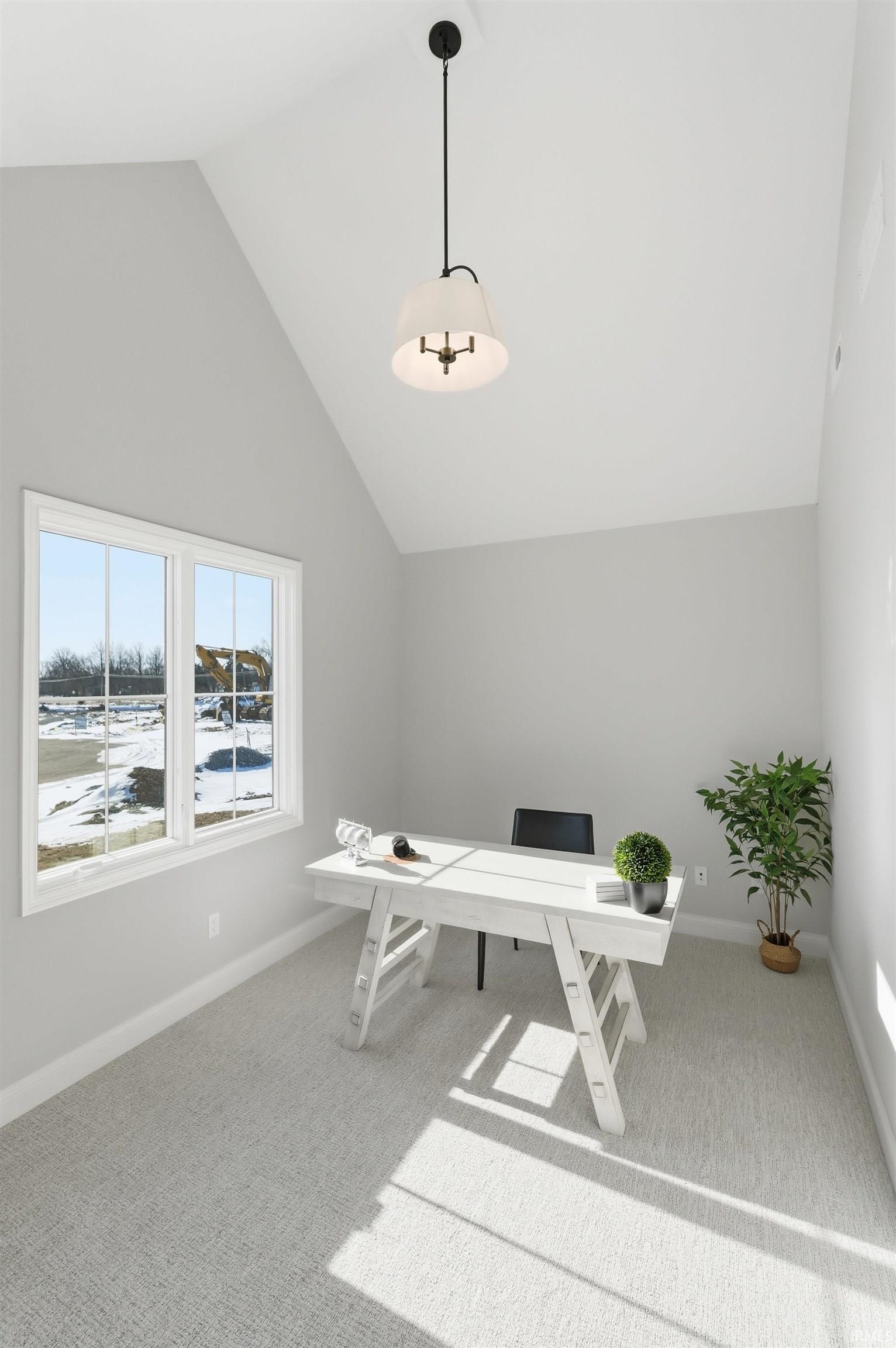 Home office featuring light carpet and high vaulted ceiling