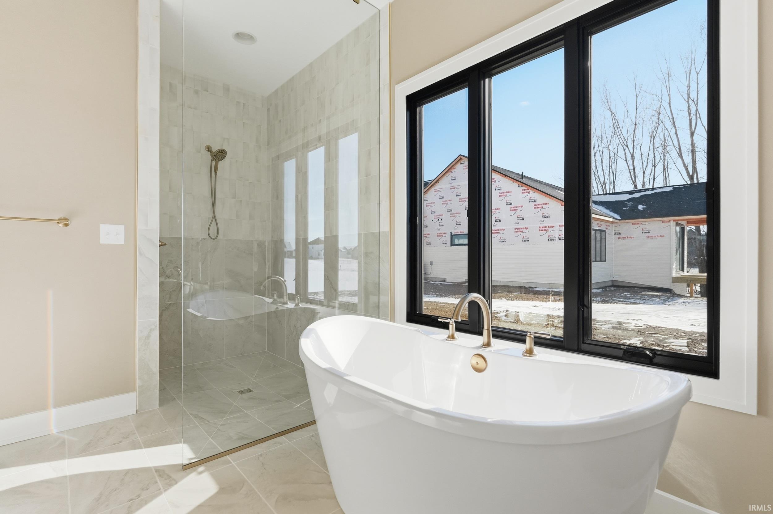 Full bath with a soaking tub and tiled shower