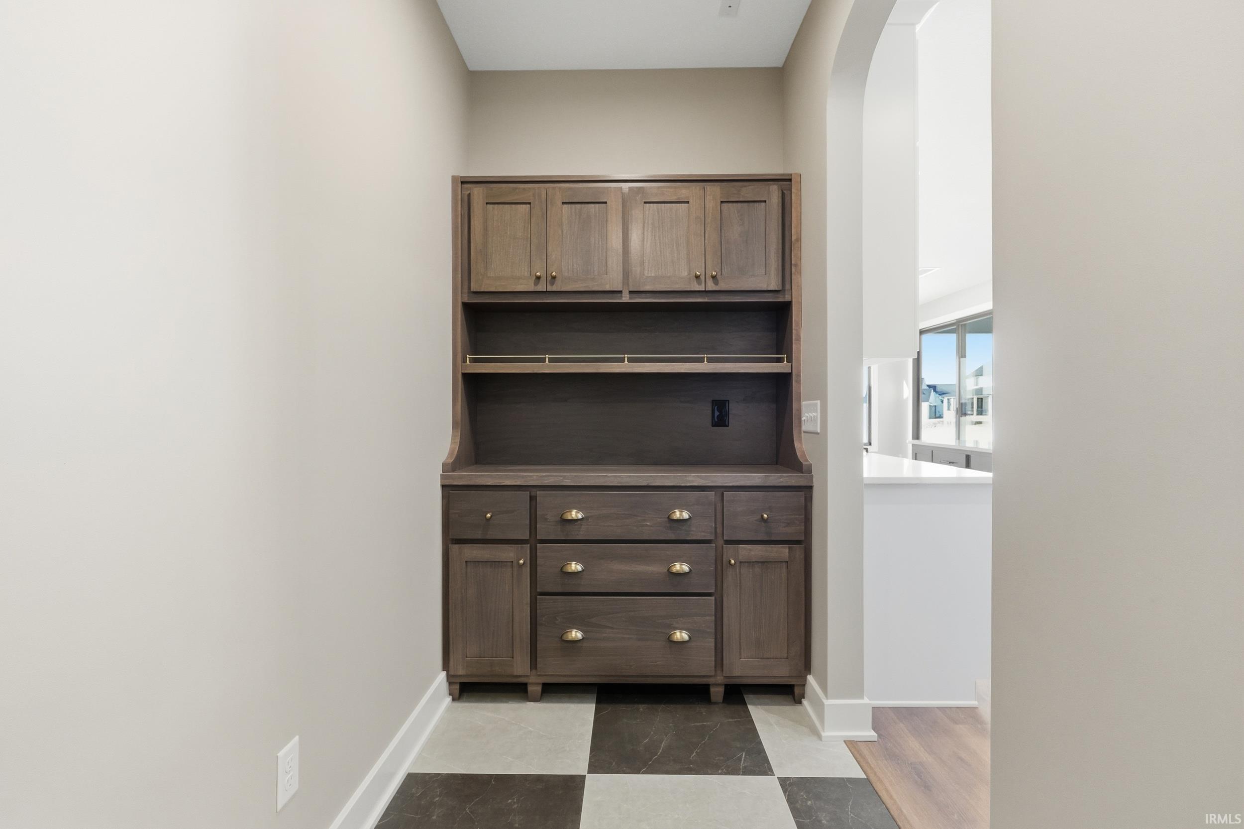 Custom cabinets, checkered tile and arched walkways