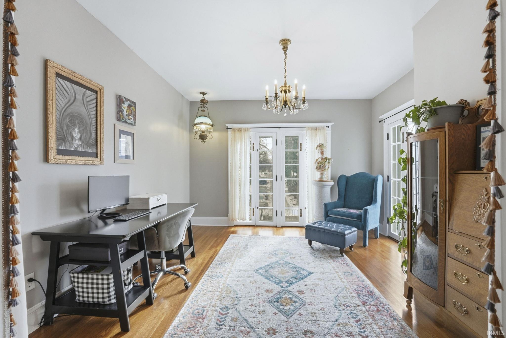 Morning room at the top of the stairs with french doors, light wood-style flooring, and ample sunlight