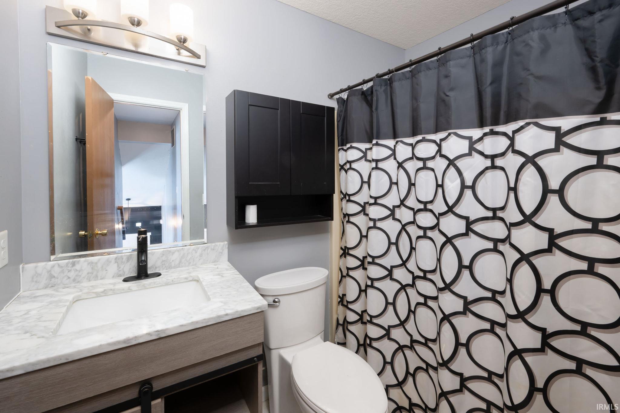 Full bath featuring vanity and a shower with curtain