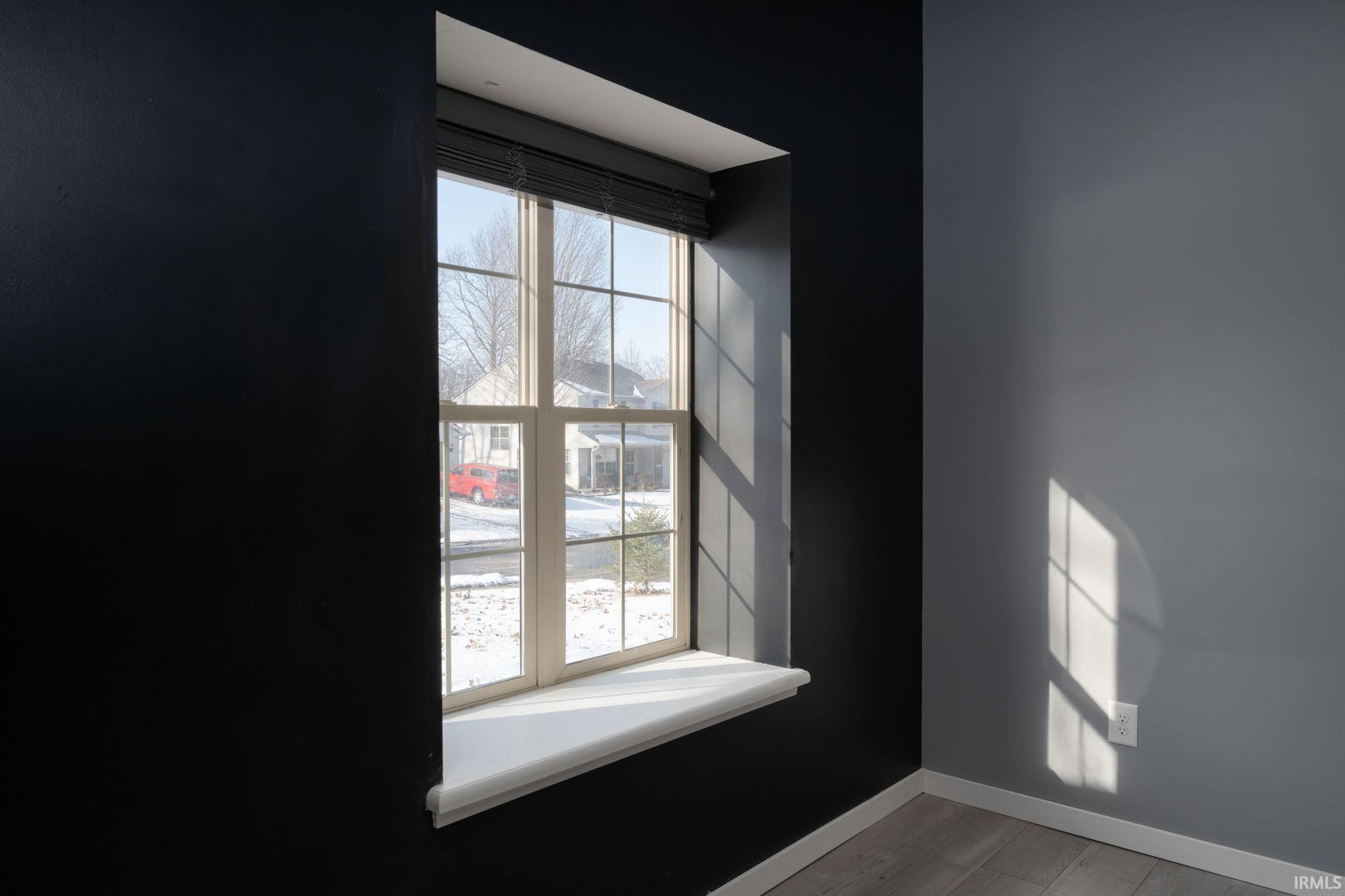 Detailed view of baseboards and wood finished floors