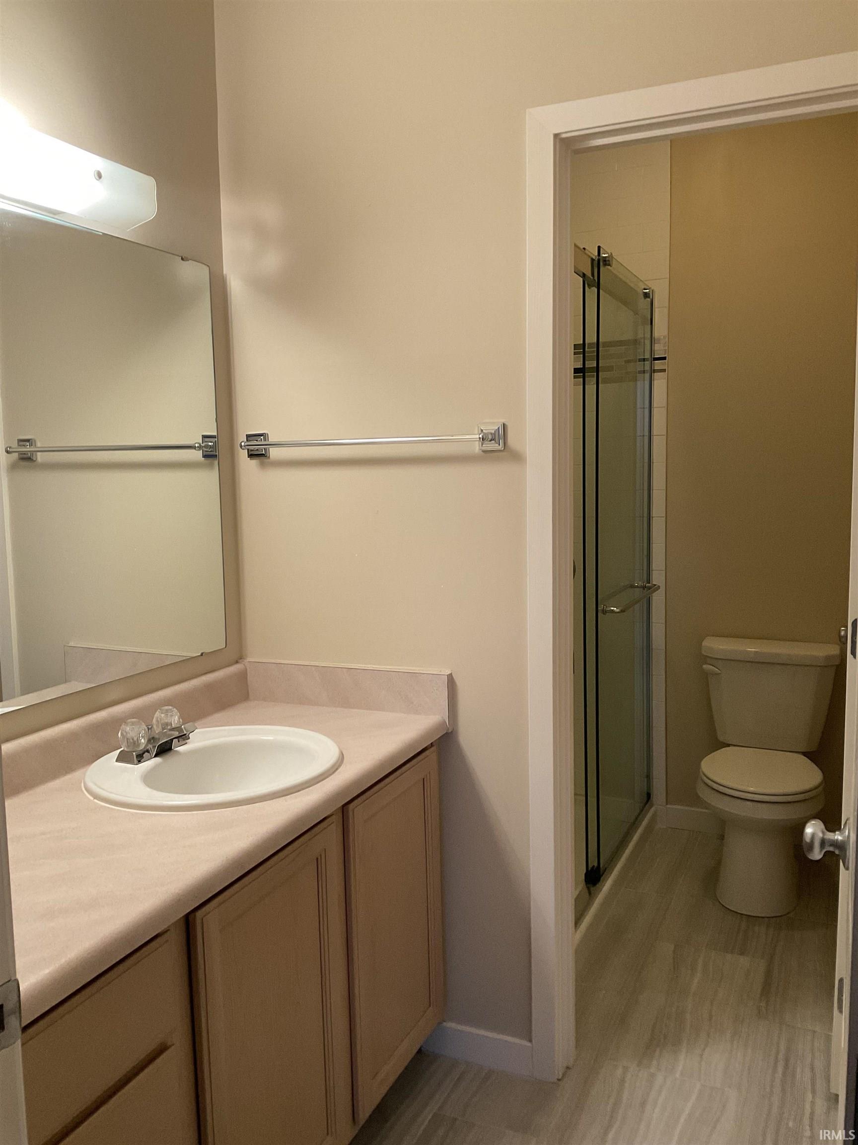 Bathroom with vanity and a shower stall