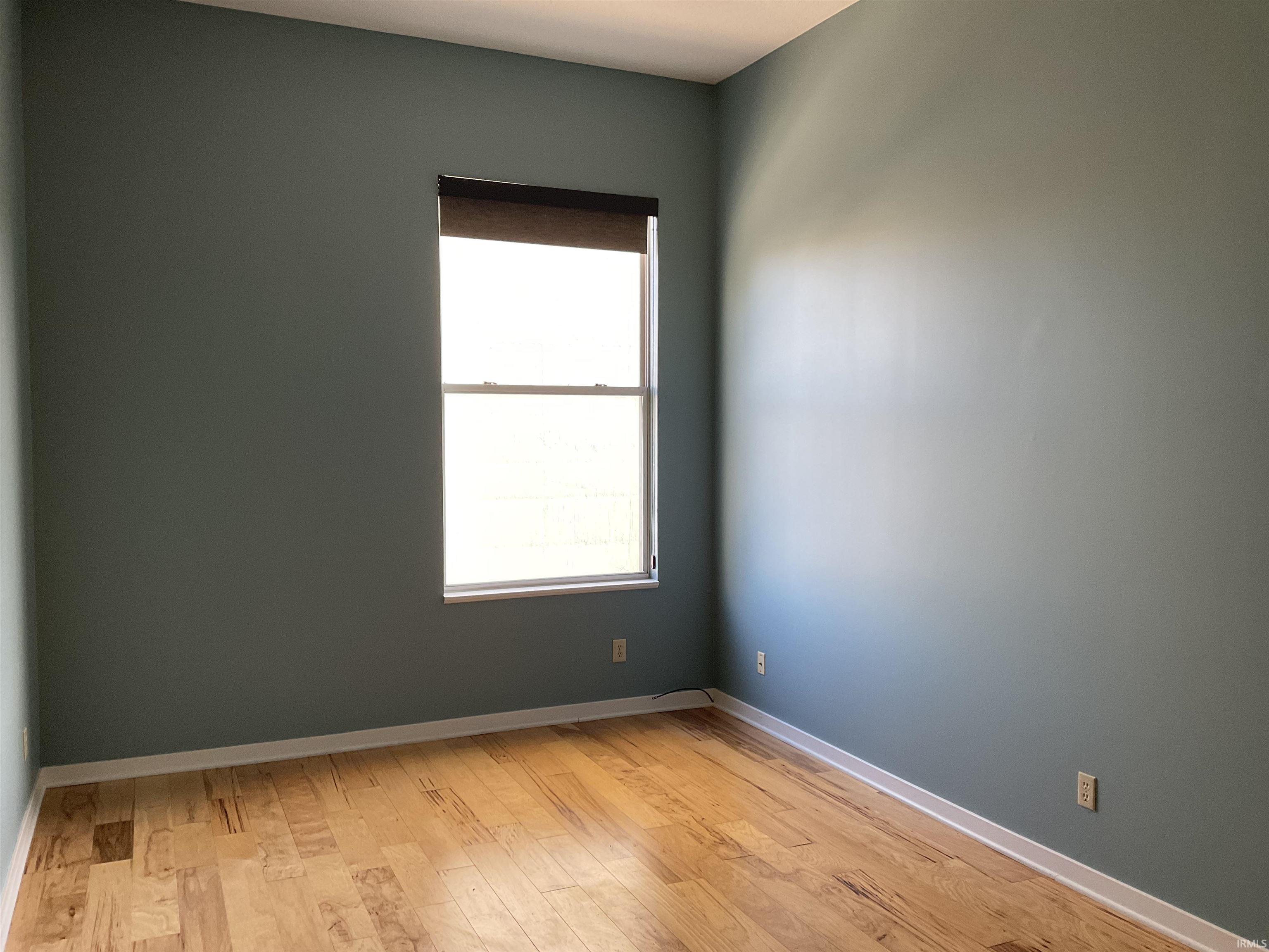 Unfurnished room with light wood finished floors.