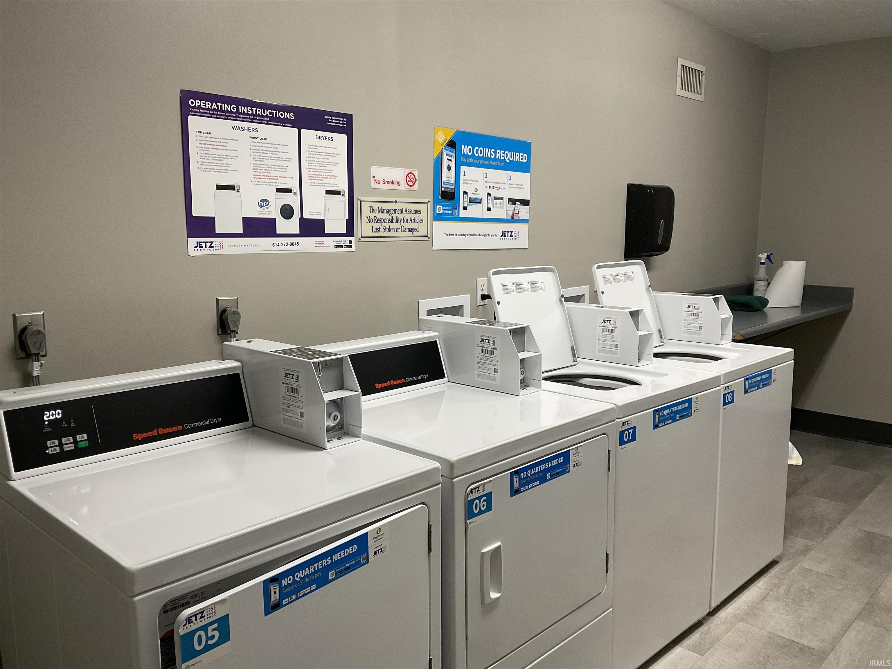 Community laundry room on the 3rd floor featuring washing machine and dryer