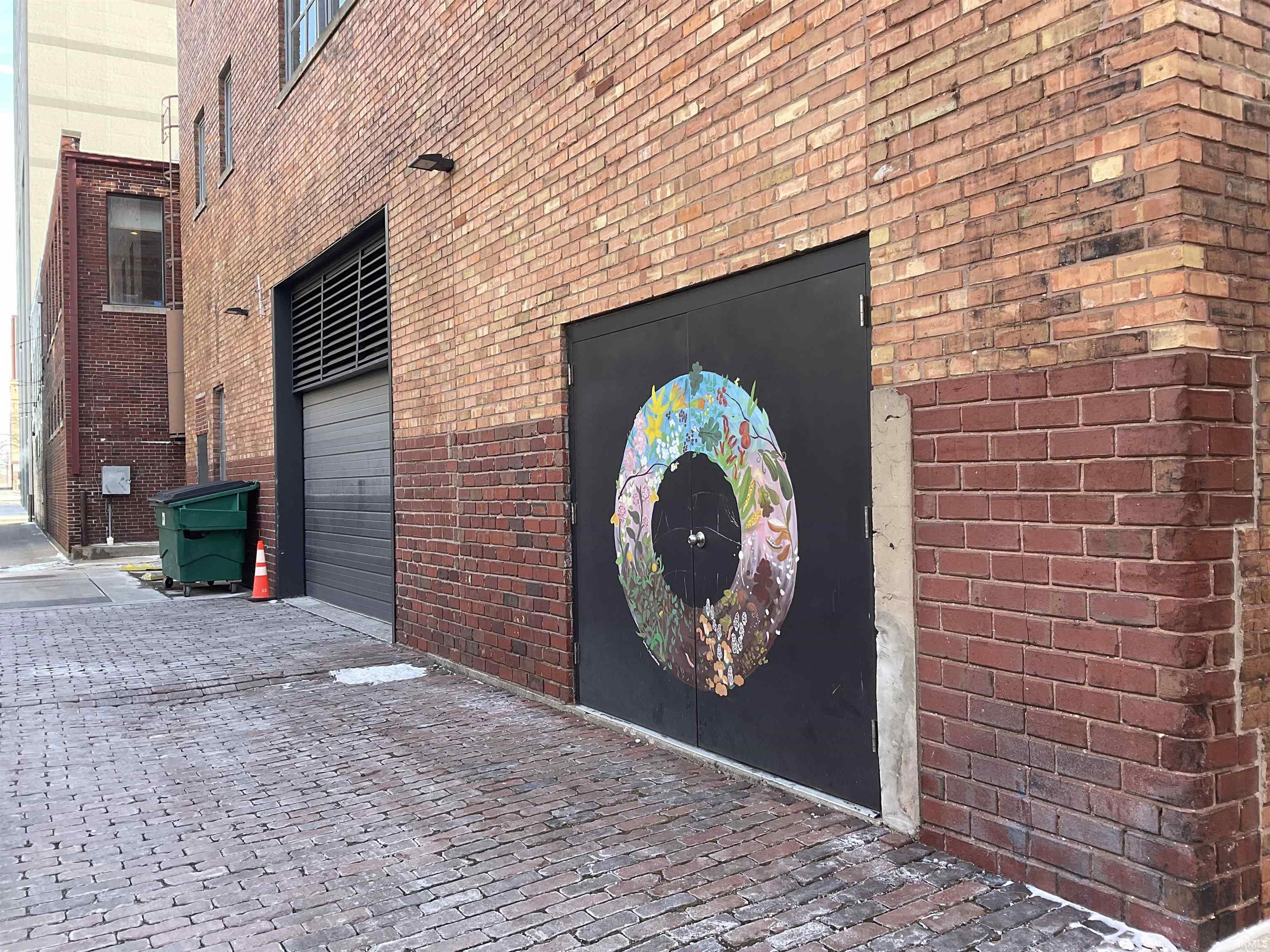 View of garage entry featuring brick exterior