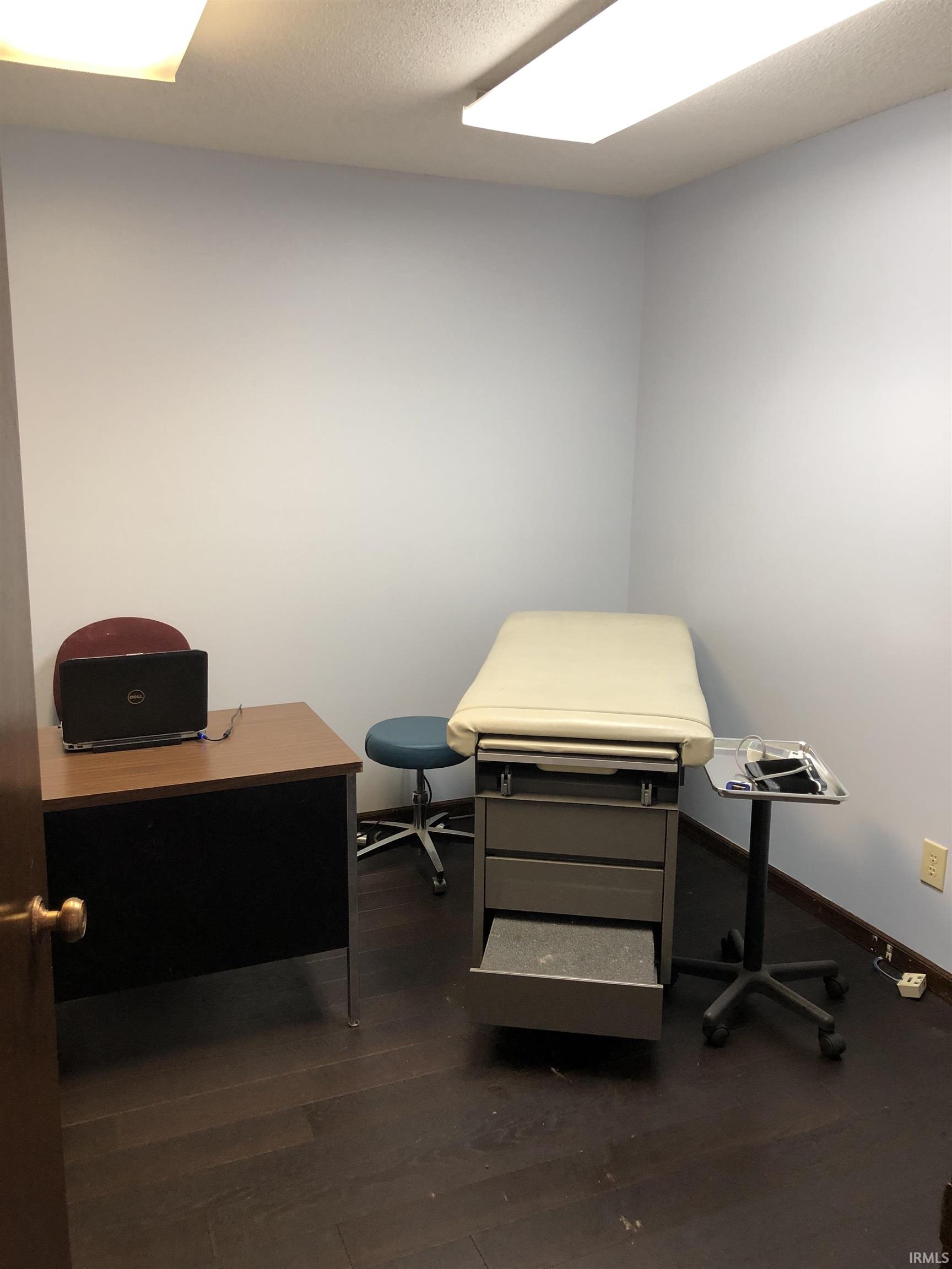 Misc room featuring a desk and dark wood finished floors