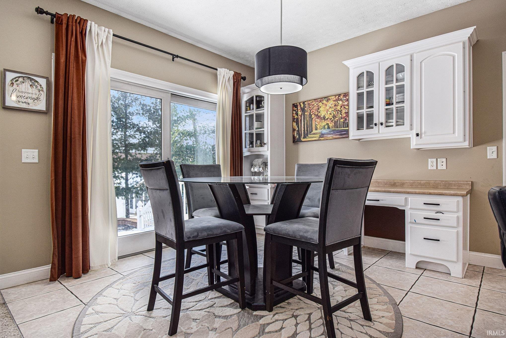 Dining room featuring light tile patterned flooring and an office area