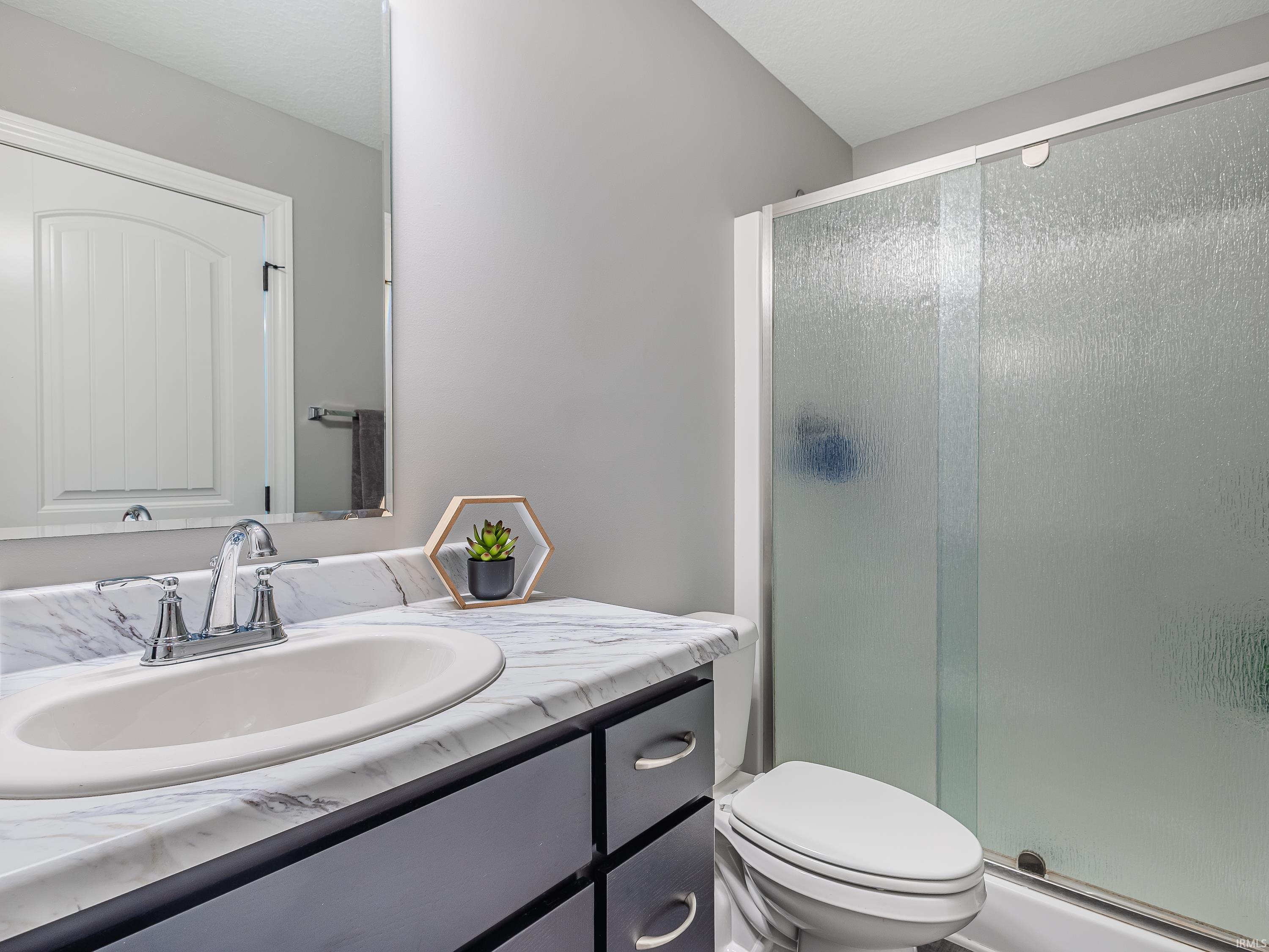 Full bath featuring vanity and a stall shower